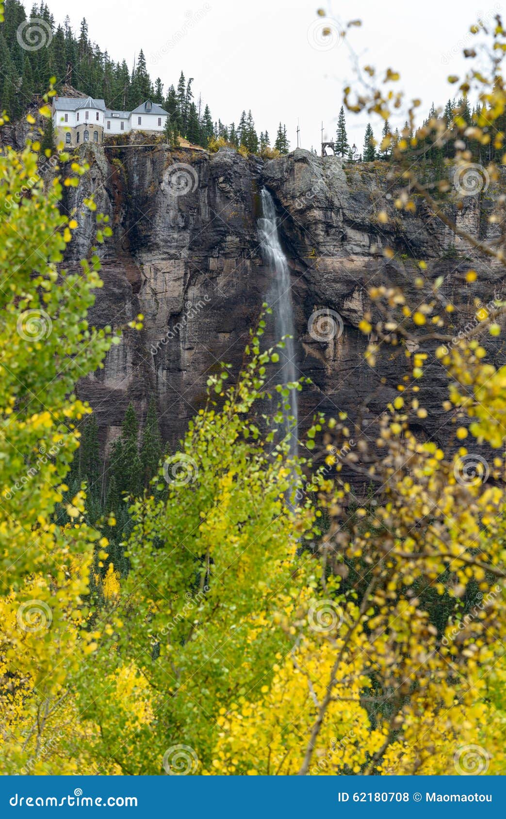 Autumn at Bridal Veil Falls. Autumn view of towering Bridal Veil Falls and its historic hydroelectric power plant at the top. The 365-feet high Bridal Veil Falls, at the side of Ingram Peak, are the tallest free falling falls in Colorado. Telluride, Colorado, USA.