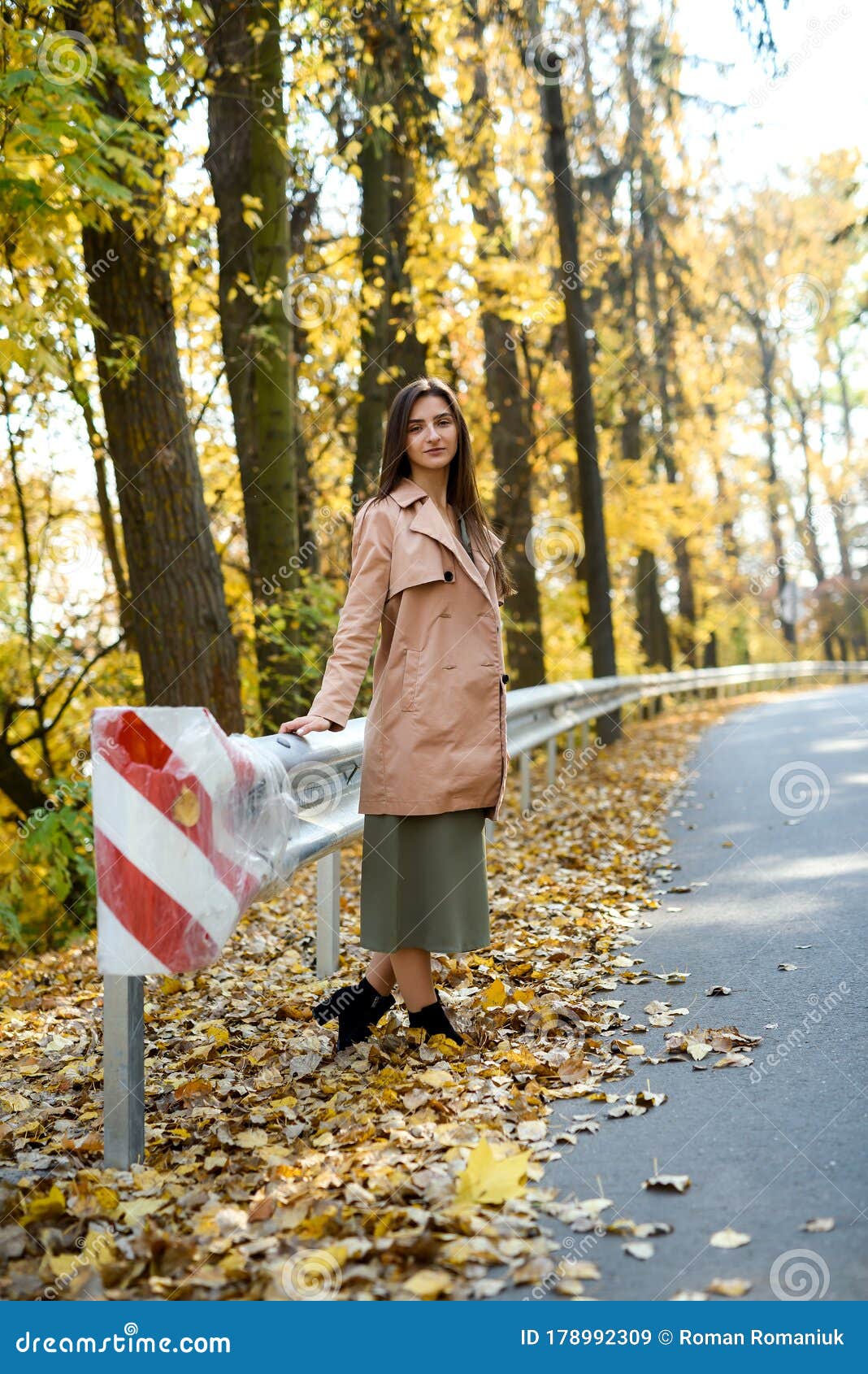 Autumn Colours. Beautiful Woman in Coat Posing in Forest on Roadside ...