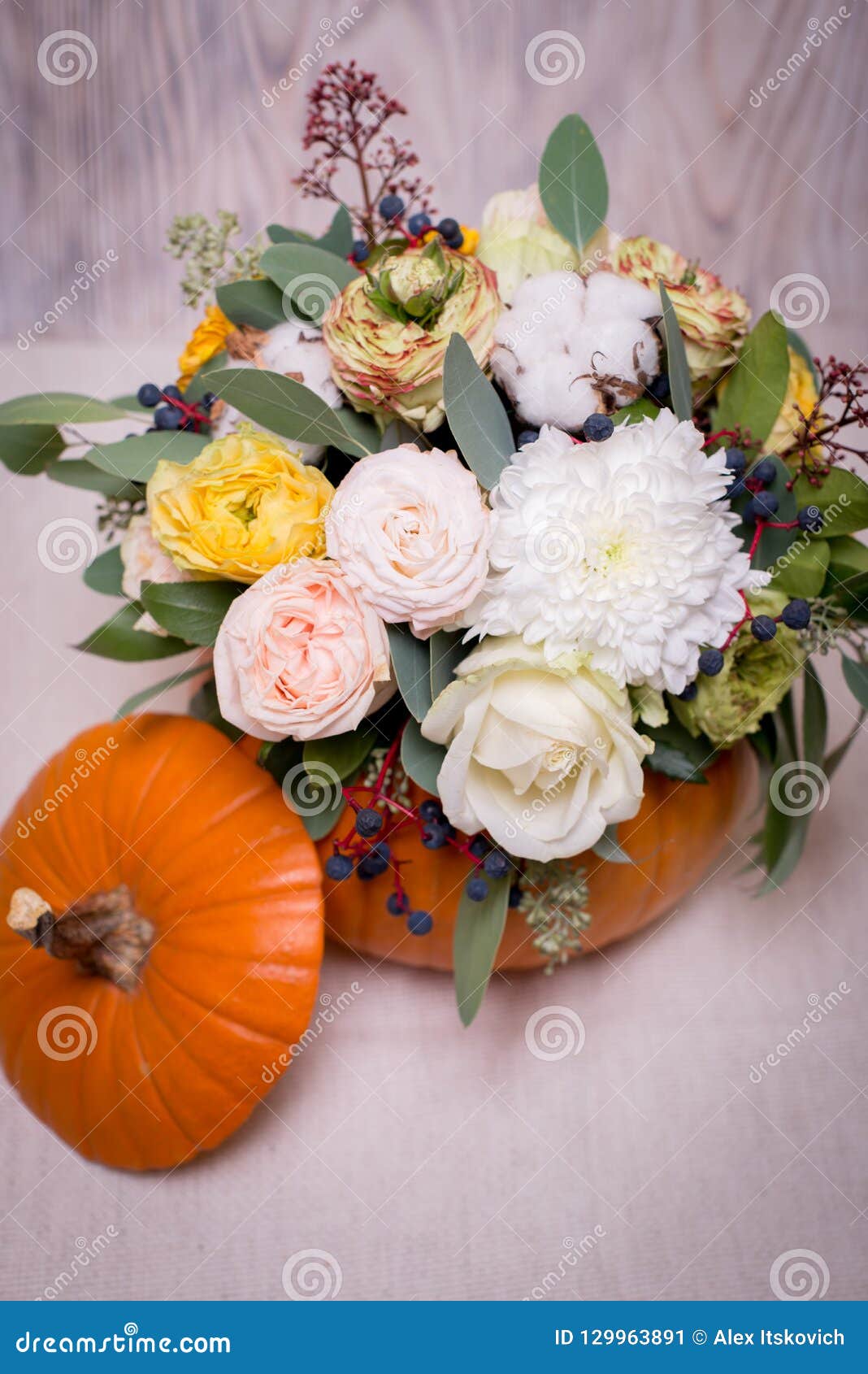 Autumn Floral Bouquet In A Pumpkin Vase A Light autumn floral bouquet pumpkin vase light background mixture flowers pionic rose eucalyptus chrysanthemum