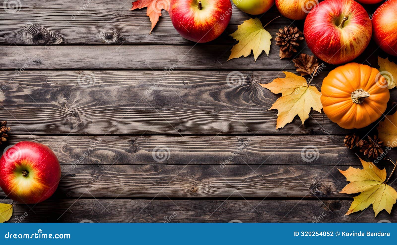 autumn harvest background with pumpkins, apples, and fall leaves on rustic wood - copy space