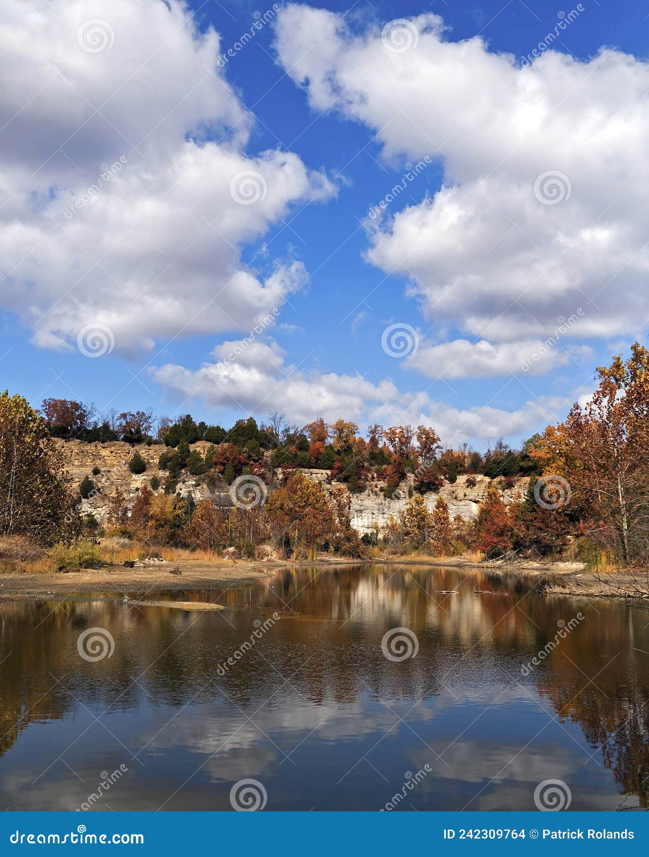 Autumn Landscape with Lake Reflecting Cloudy Sky and Rock Bluffs Stock ...