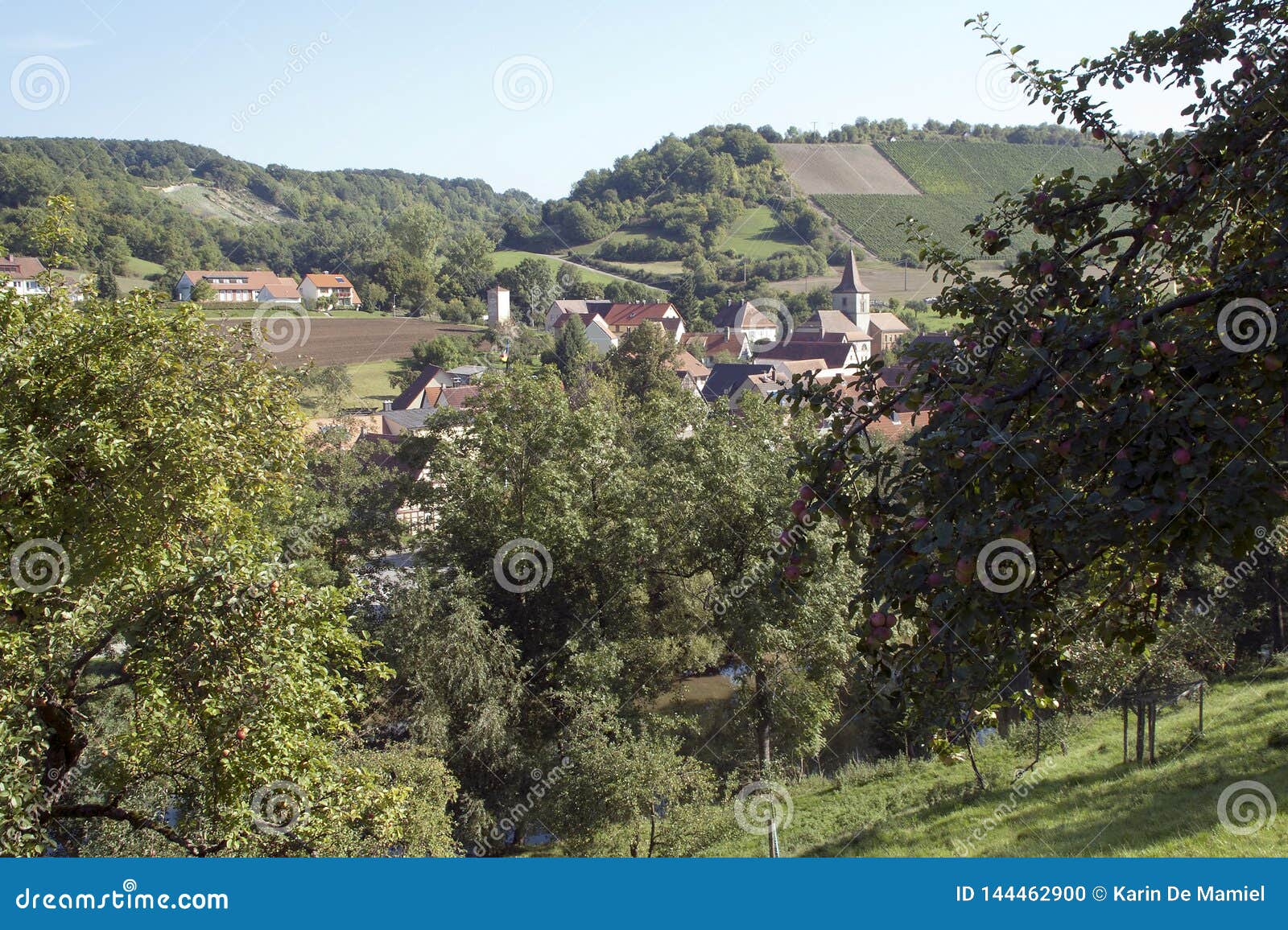 rural village with plowed fields and apple orchards
