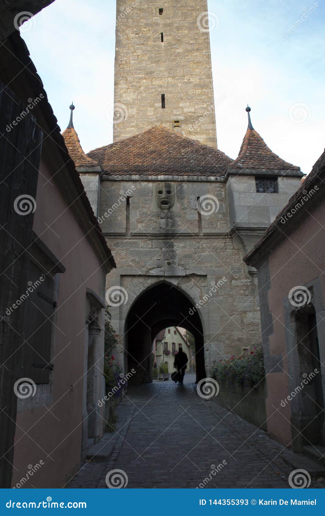 cobblestone street and burgtor or castle gate