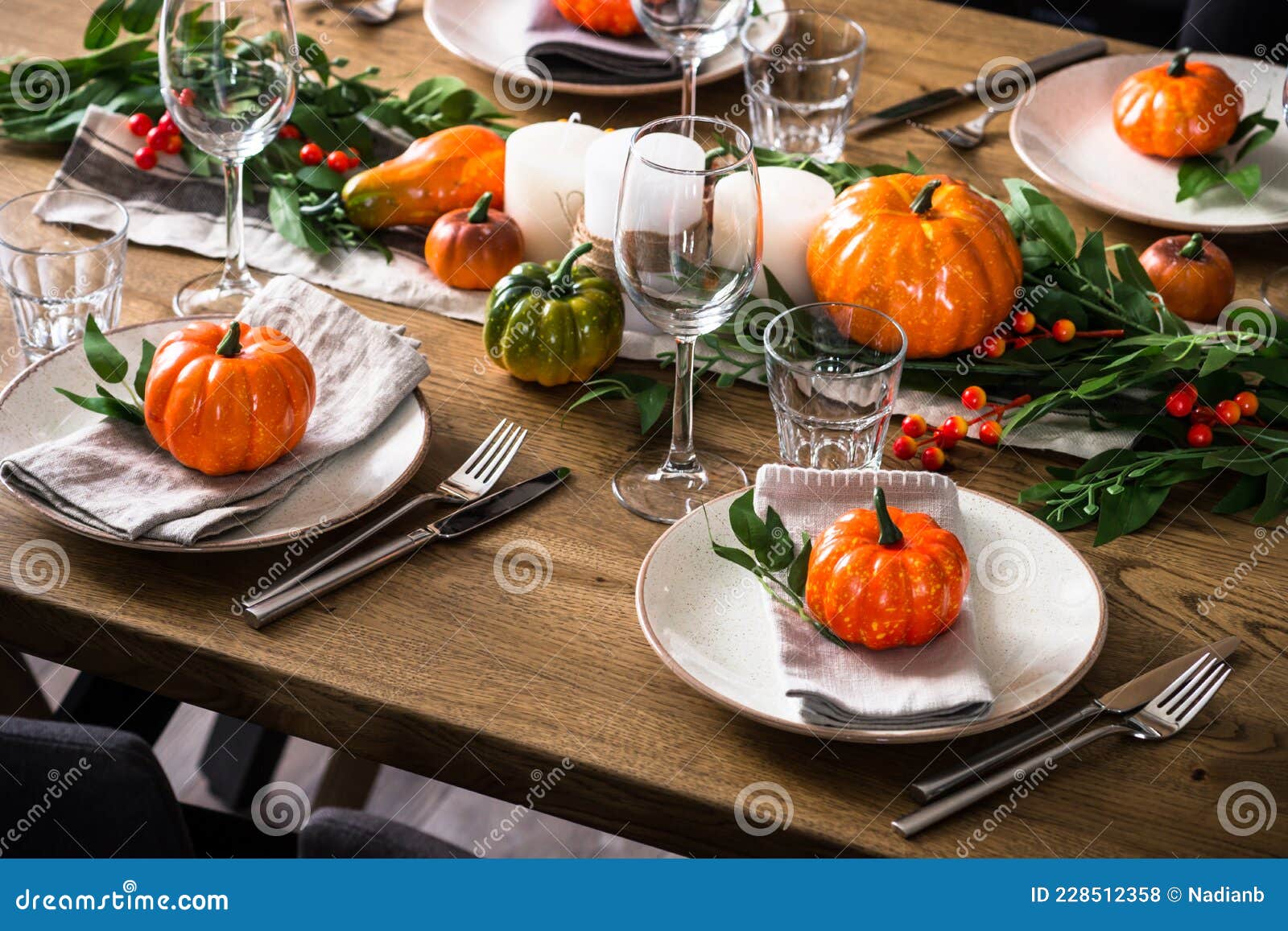 autumn table setting with plate, pumpkin and candles.