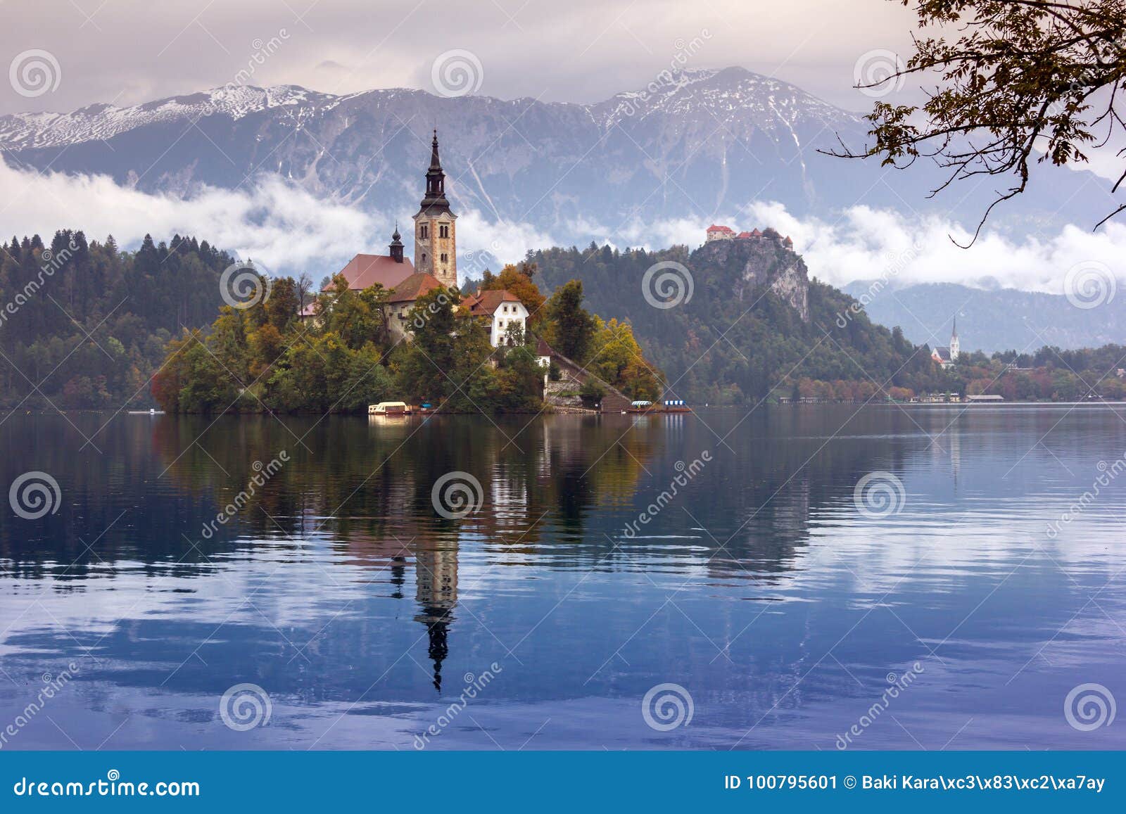 autumn view of the historical church on the island in lake bled