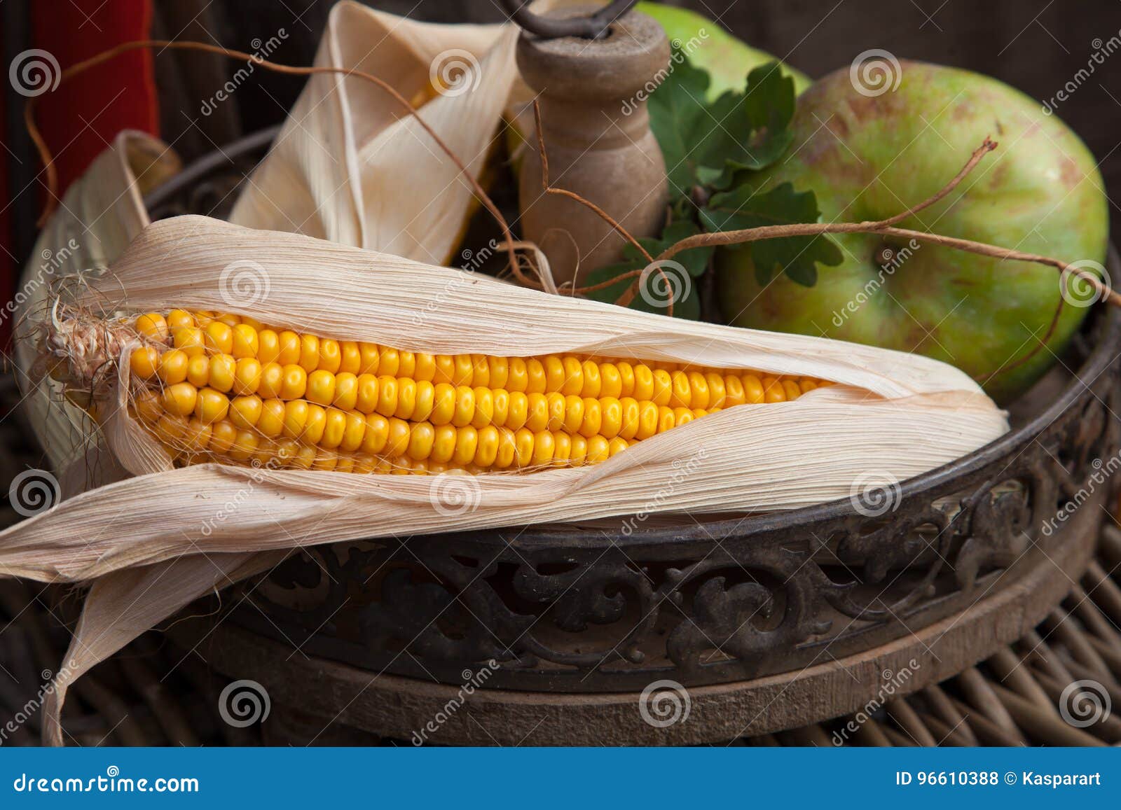 autumnal stilllife with corn cob and apple
