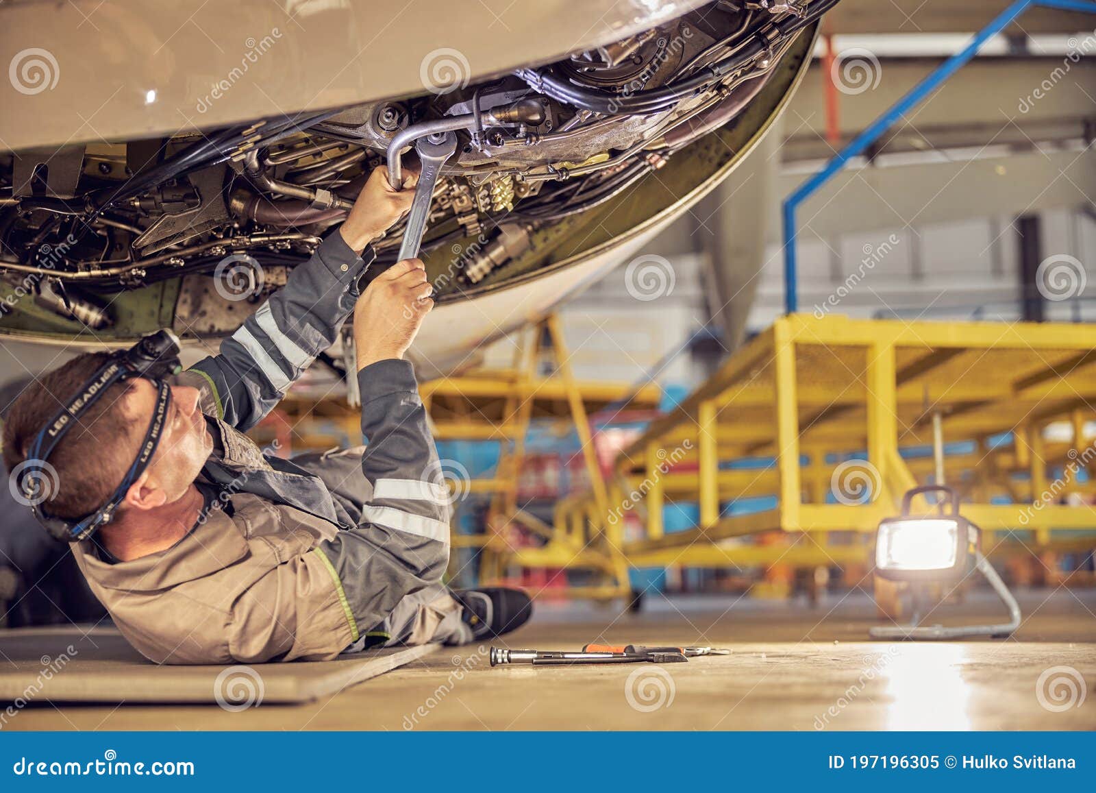 aviation mechanic is checking big jet before departure