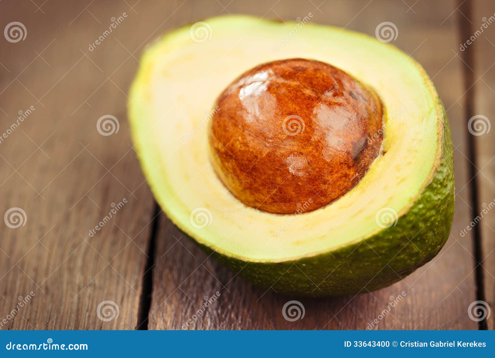 Sliced avocado fruit on brown wooden old table.