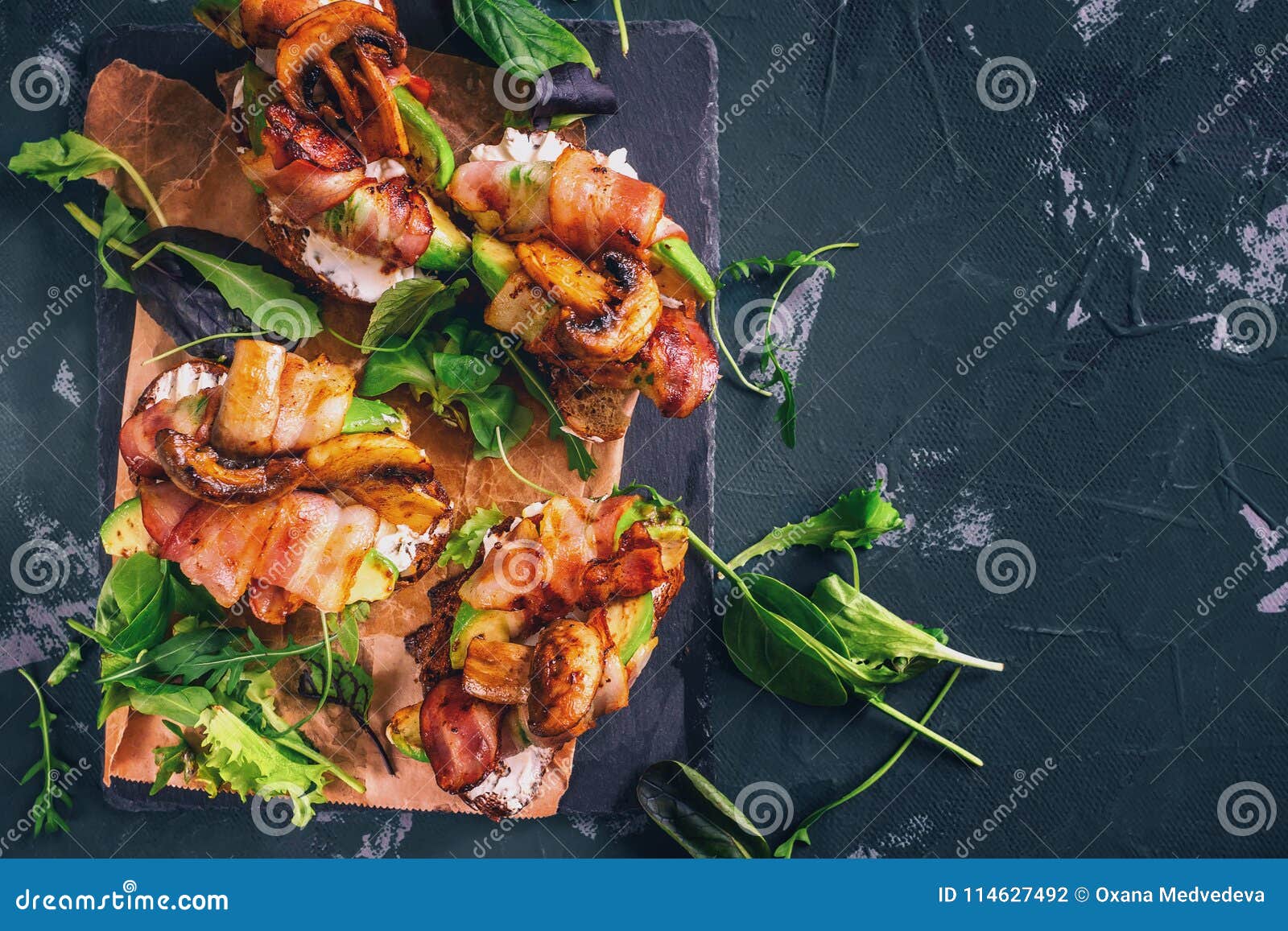 avocado sandwich with homemade ciabatta bread, cooked with fresh sliced avocado and fried crispy bacon and mushrooms. copy space f