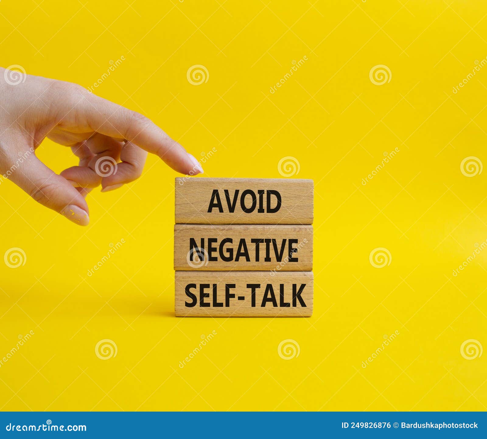 avoid negative self-talk . concept words avoid negative self-talk on wooden blocks. beautiful yellow background. bisinessman