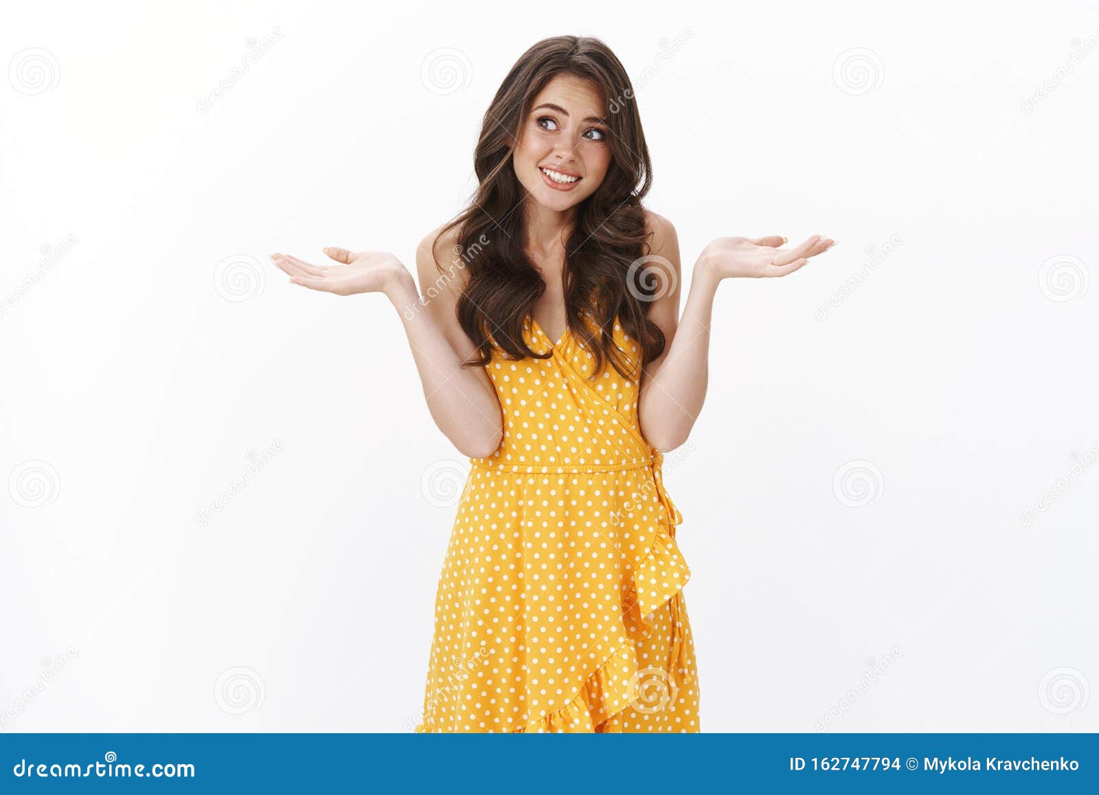 Awkward Reluctant Young Brunette In Yellow Dress Look Away Embarrassed