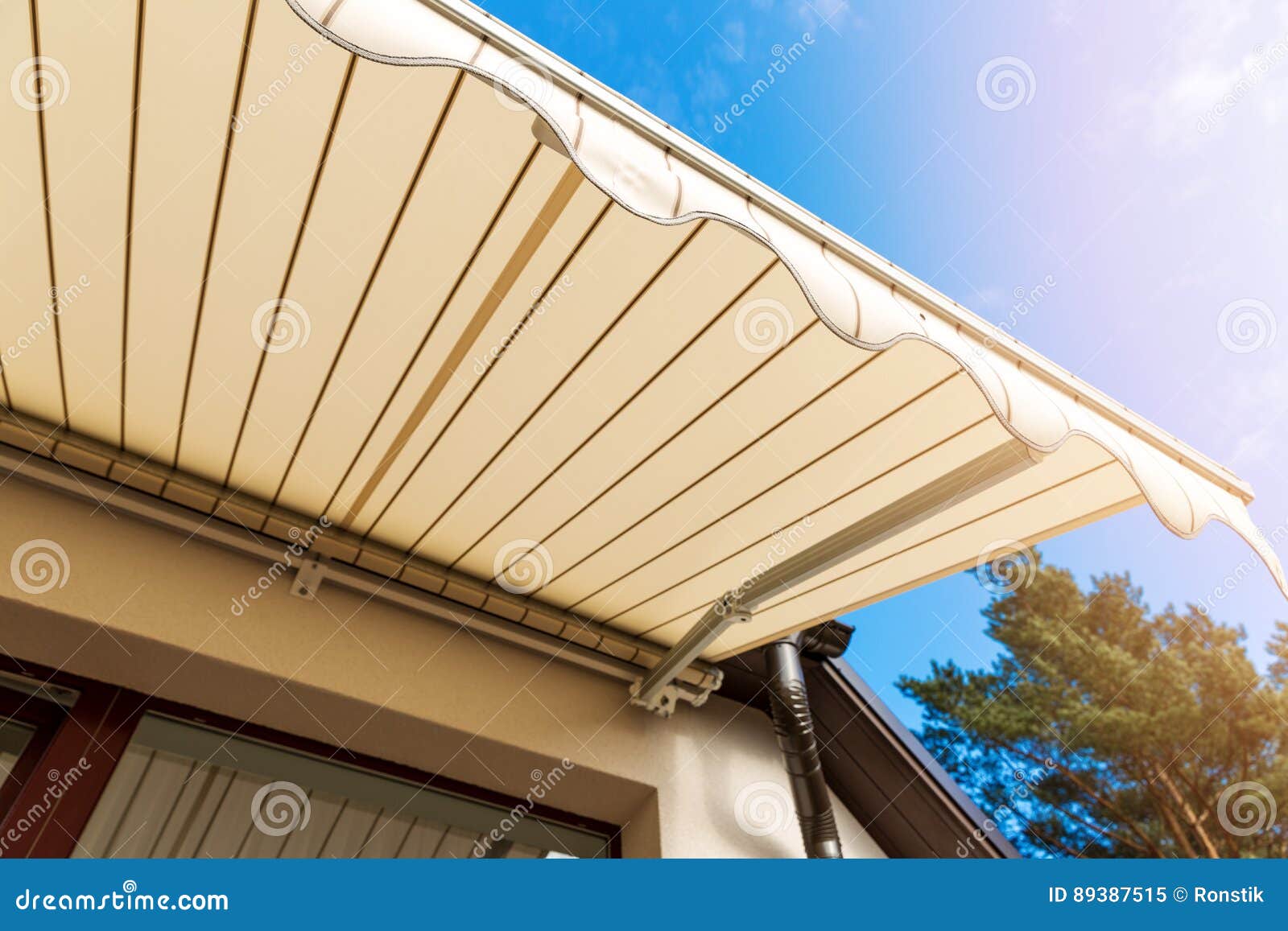 awning over balcony window against blue sky