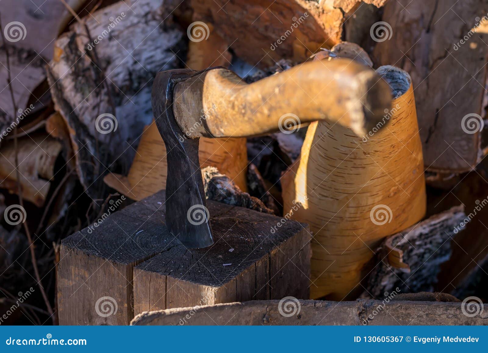 Axe Stuck in a Log in the Yard about a Woodpile on the Street Stock