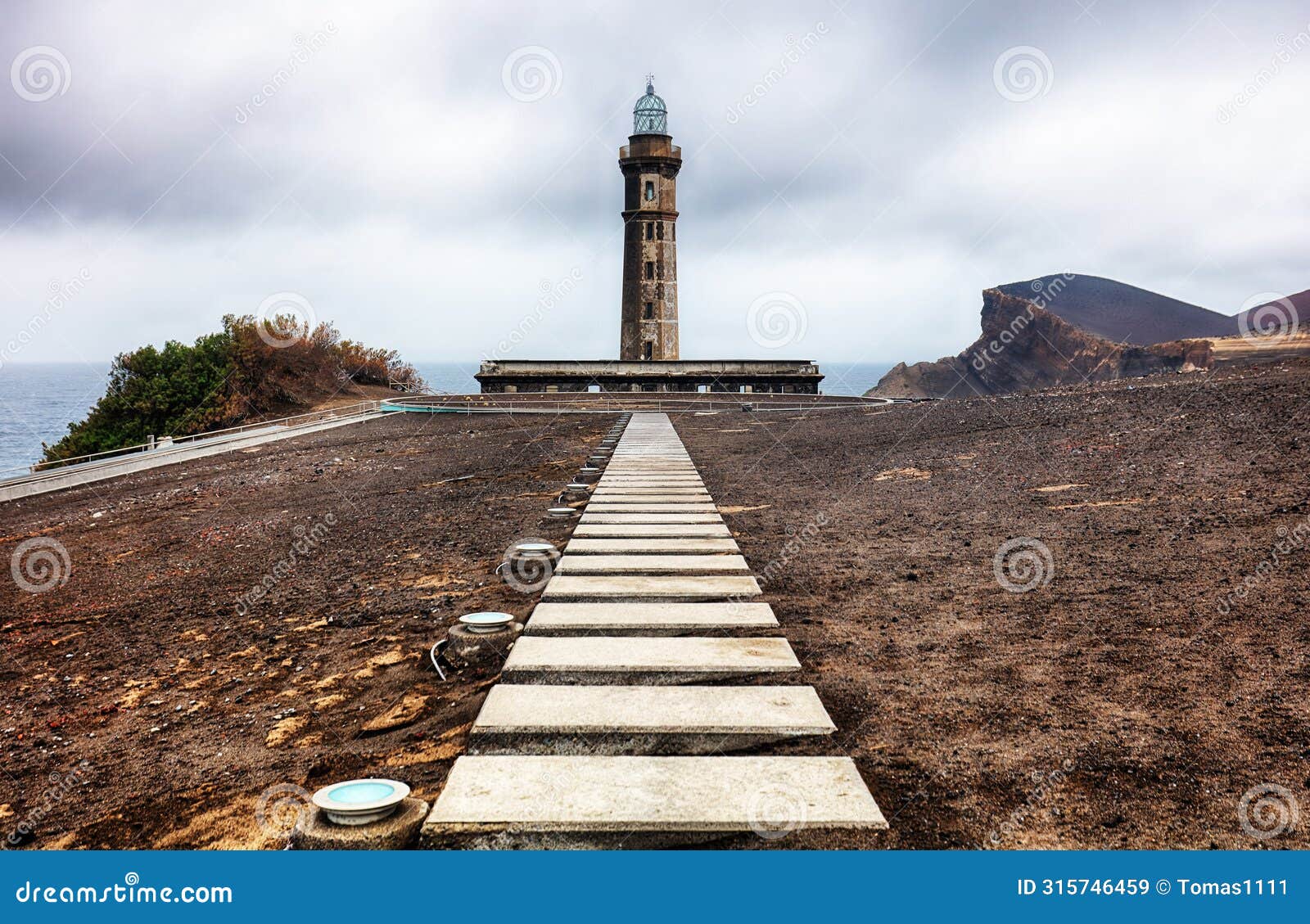 azores, island of faial. the lighthouse farol dos capelinhos at ponta dos capelinos