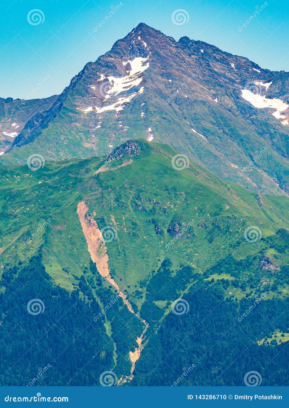 Top view of the mountain range and peaks covered with snow. Mountain peak in the summer