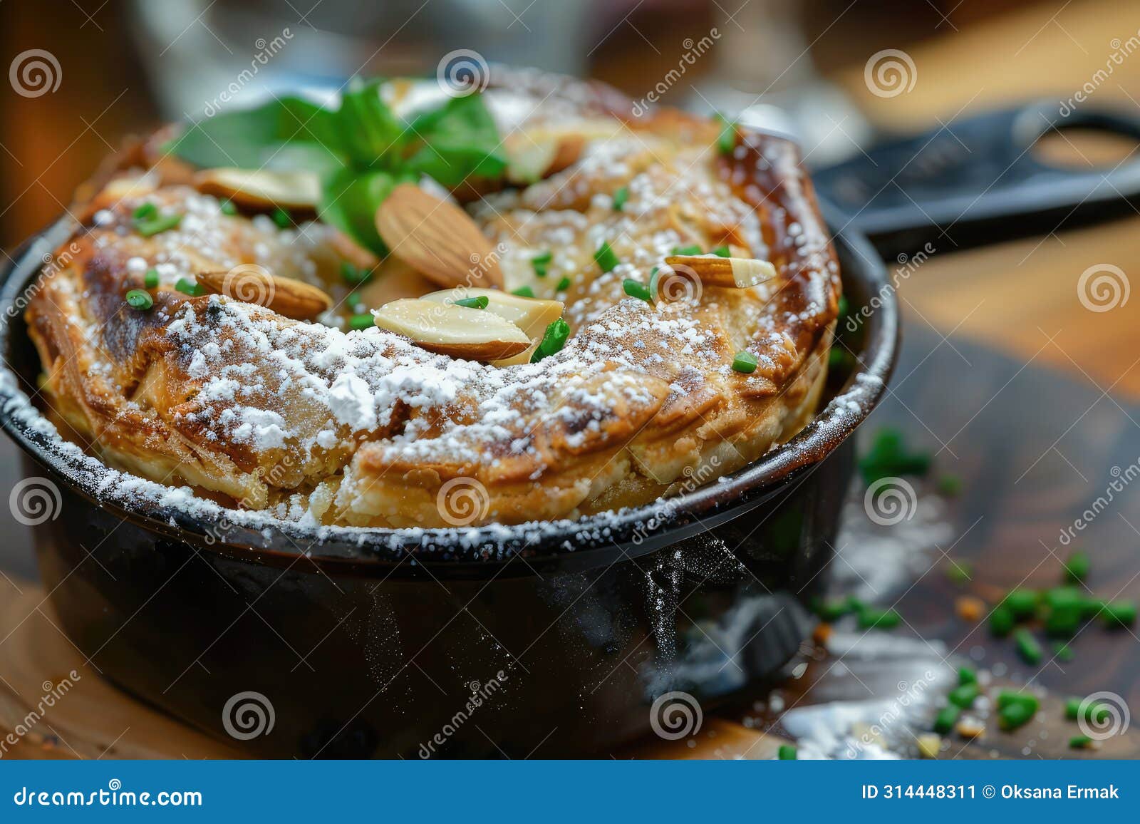 b'stilla or bastilla, a savory moroccan chicken pie, pastilla pigeon pie topped with almonds and powdered sugar