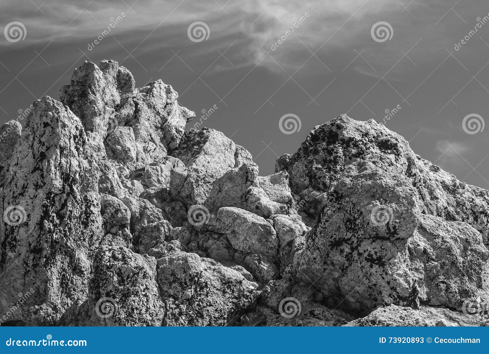 B/W Outcropping of Large Boulders. Large rocks and boulders against sky with light, wispy clouds