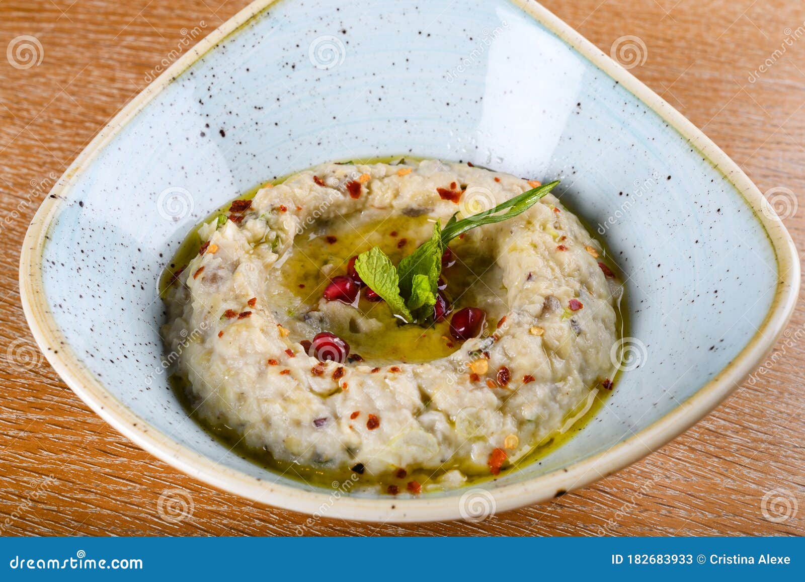 baba ghanoush, also spelled baba ganoush or baba ghanouj, is an appetizer of mashed cooked eggplant