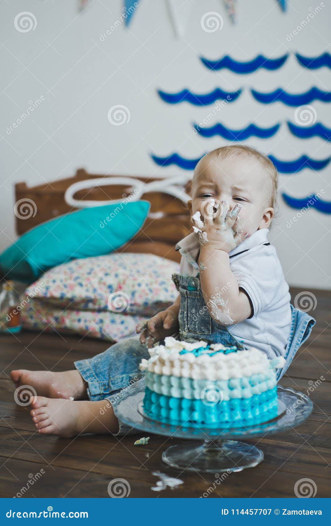 The Child Eats the Cake Hands Sitting on the Floor 5603. Stock Image