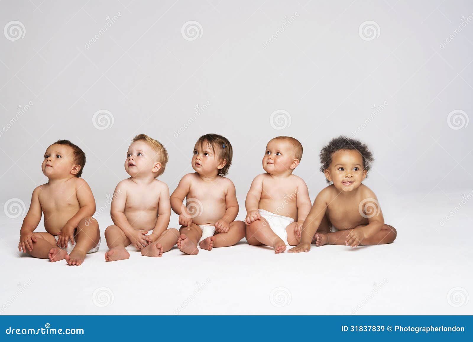 Babies Sitting Side by Side Looking Away Stock Image Image of away