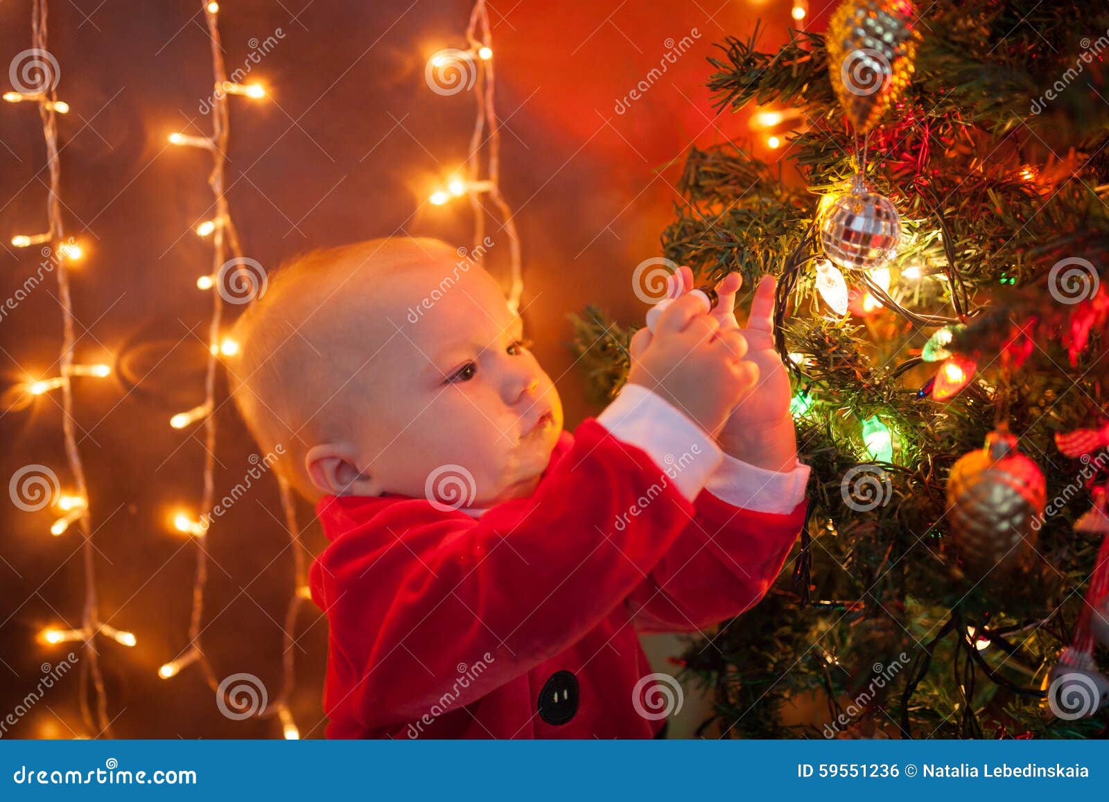 The Baby Around the Christmas Tree with Lights Stock Photo Image of