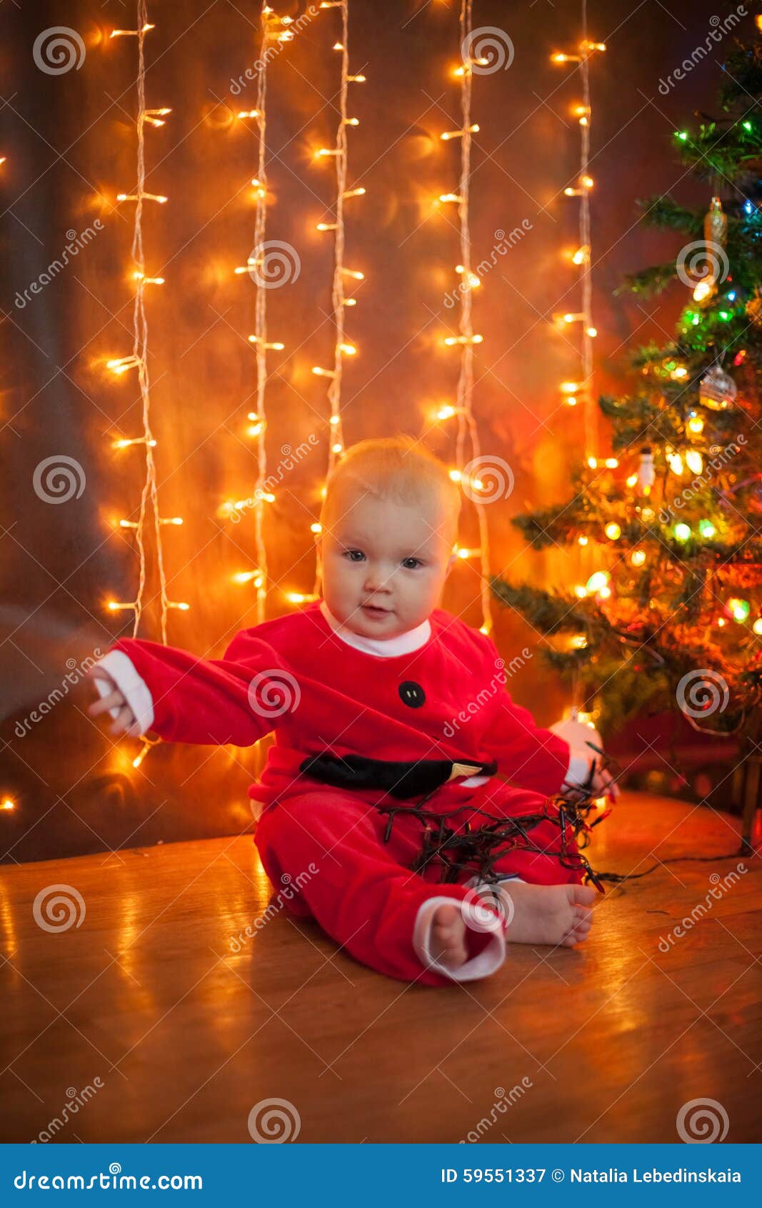 The Baby Around the Christmas Tree with Lights Stock Image Image of