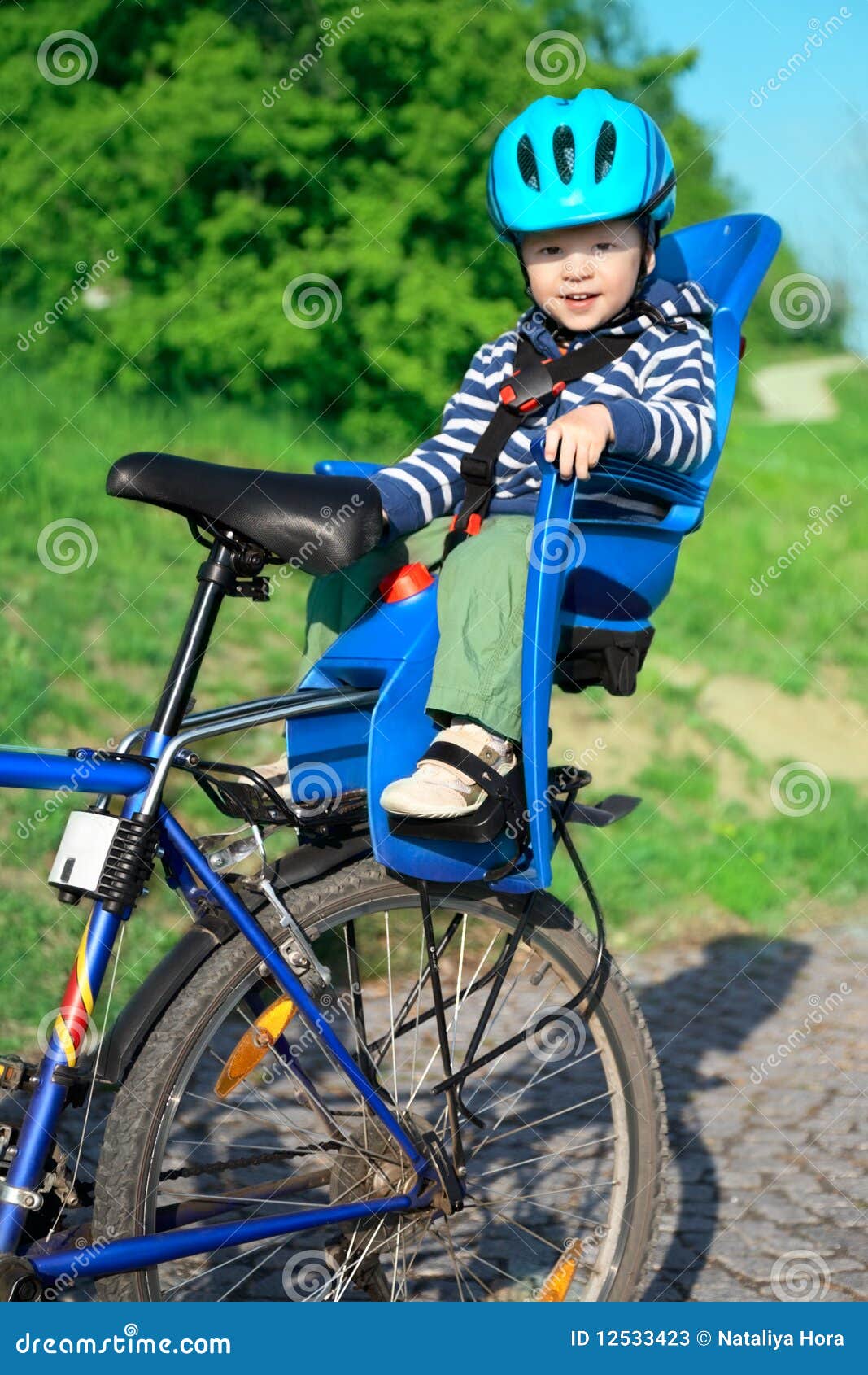 Baby in bicycle chair stock image. Image of little, nature 12533423