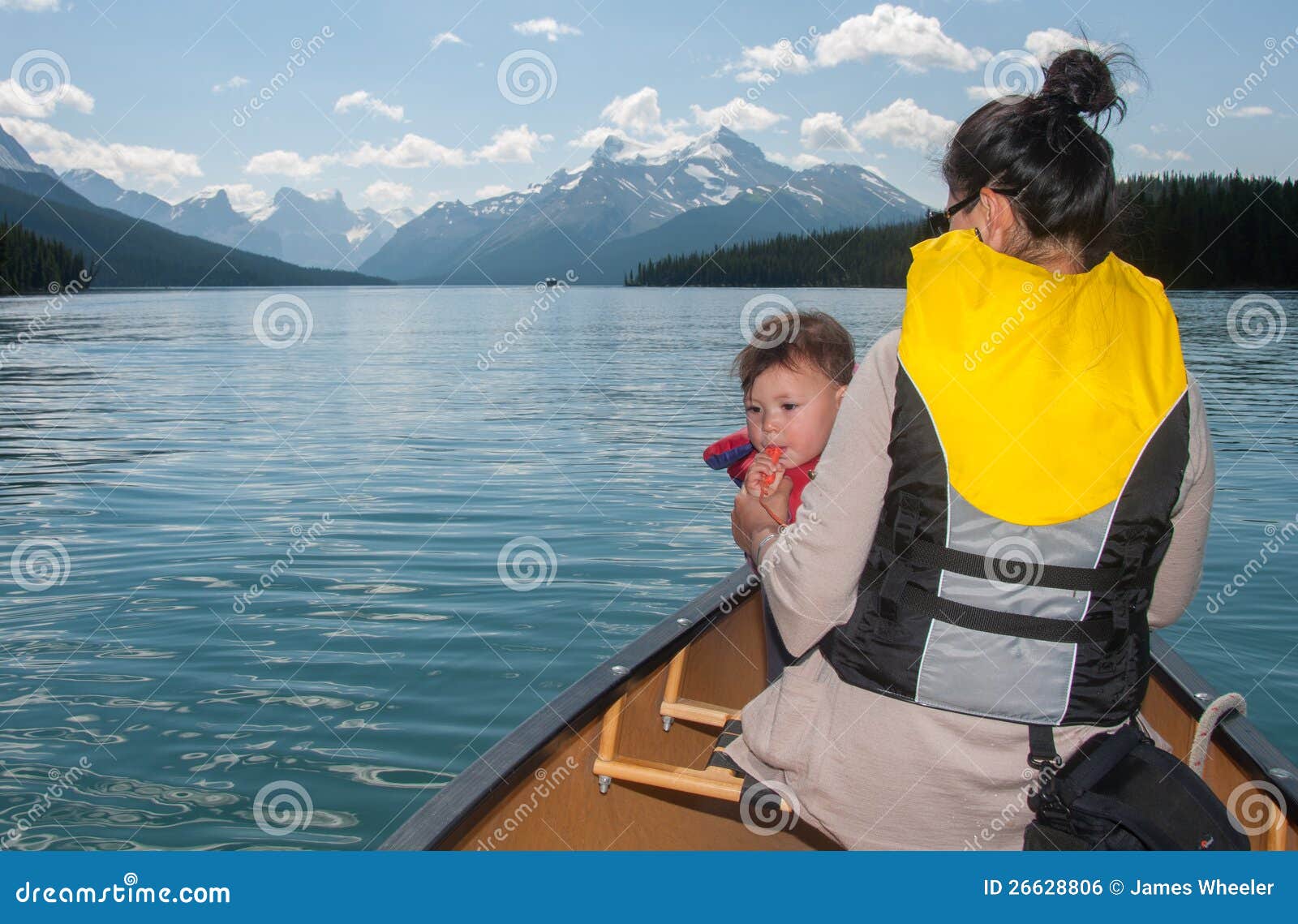Baby Blowing Whistle in Canoe with Mother Stock Photo Image of back