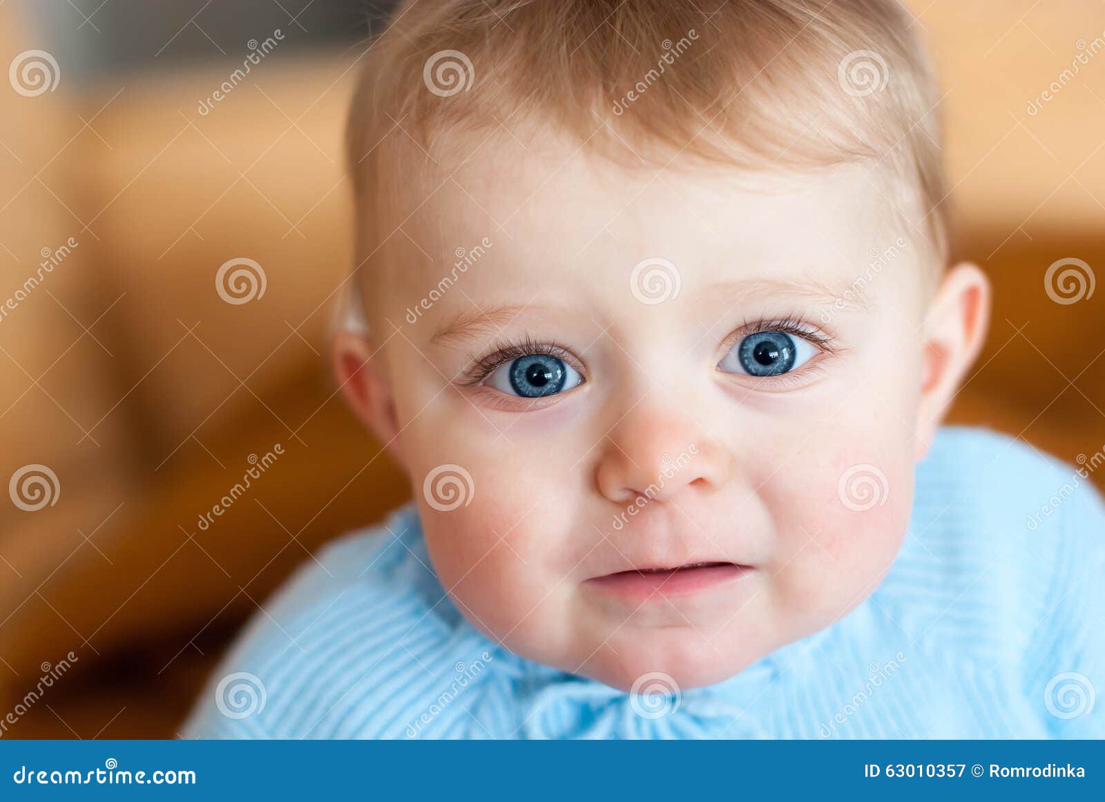 Baby With Blue Eyes Looking At Camera Indoors Stock Image Image Of