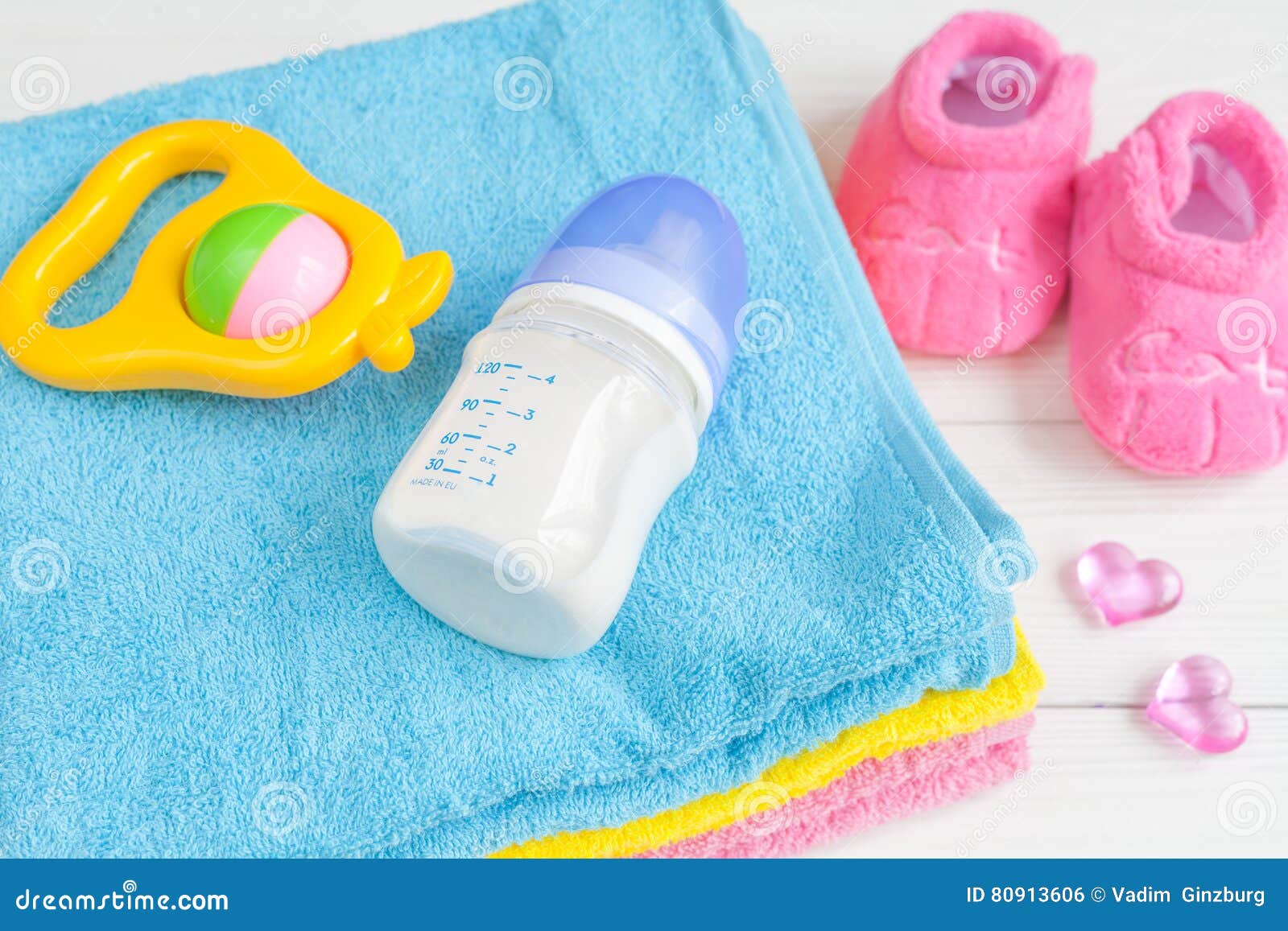 Baby Bottle With Milk And Towel On Wooden Background Stock Photo ...