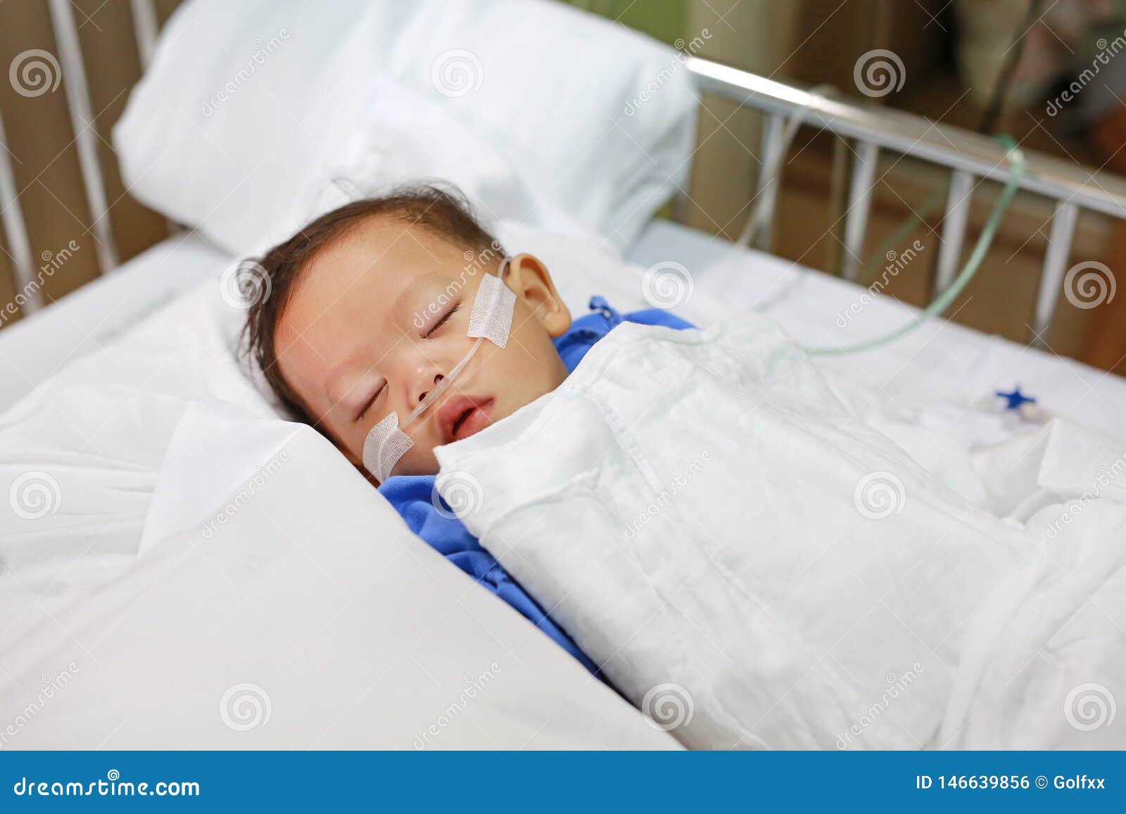 baby boy age about 1 year old sleeping on patient bed with getting oxygen via nasal prongs to assure oxygen saturation. intensive