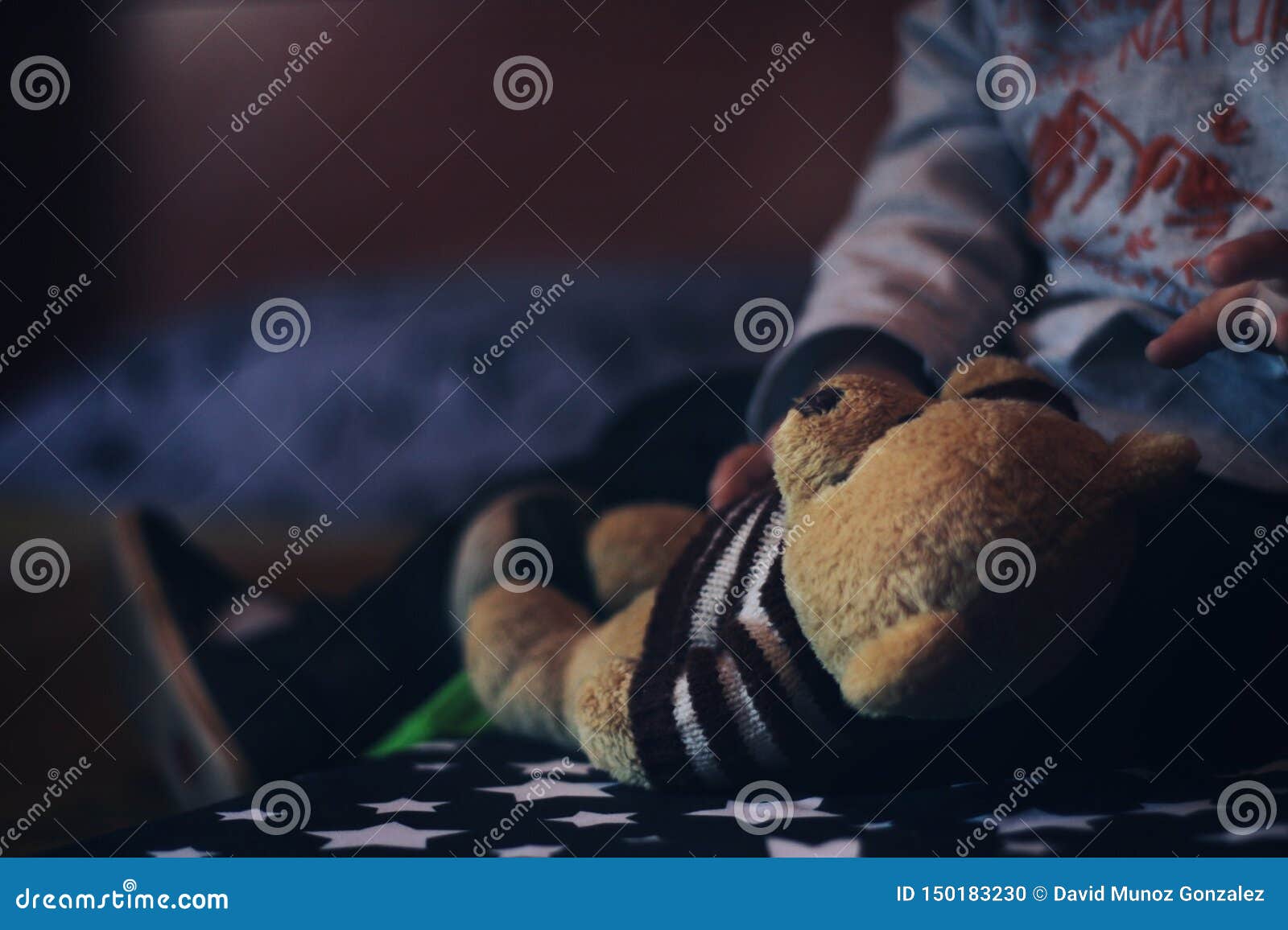 baby playing with a teddy bear.