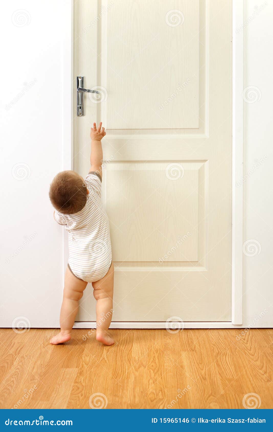 Baby boy in front of door stock photo. Image of reach 15965146