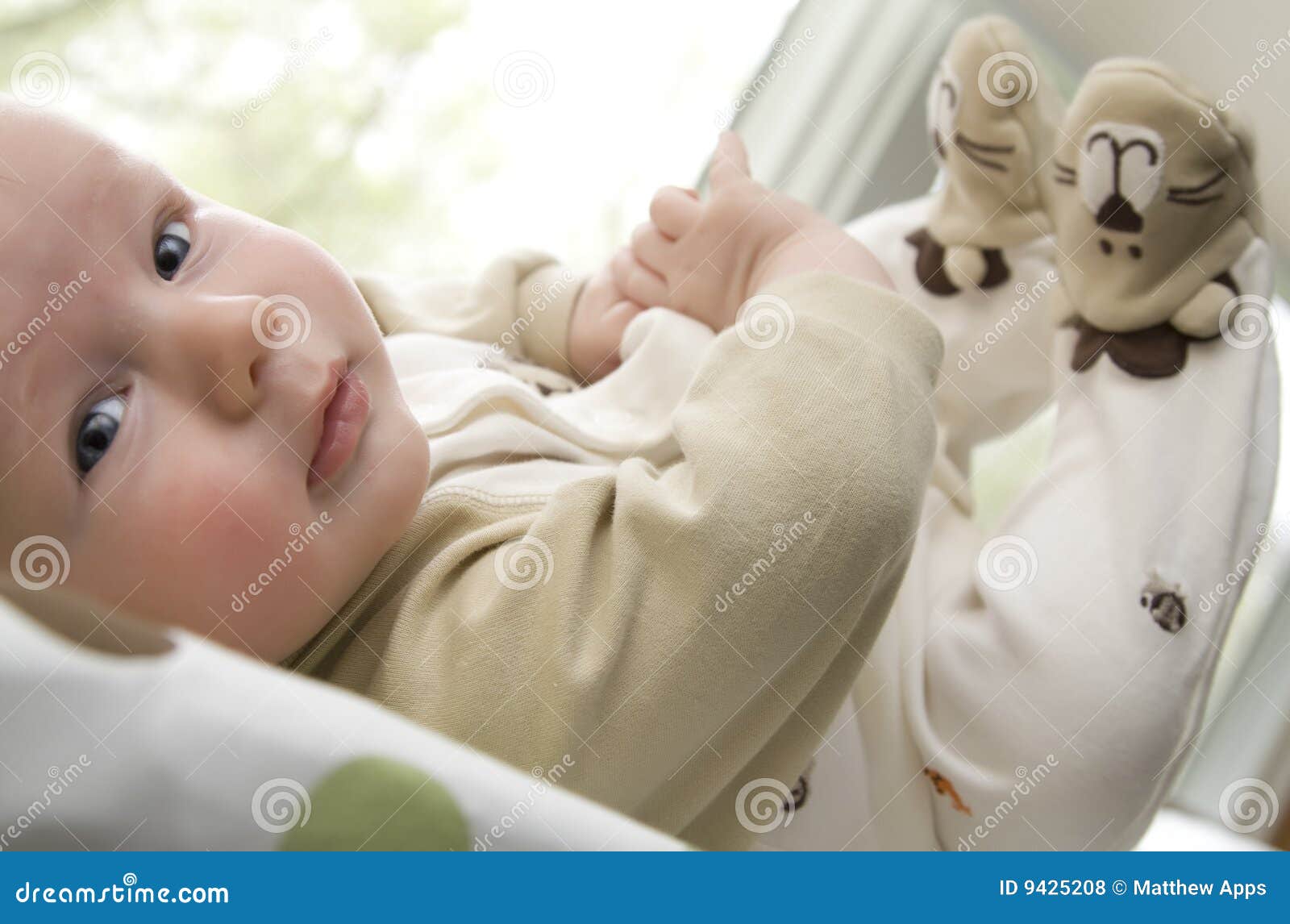 Baby Boy Lying On Back With Feet Up In The Air Stock Photo