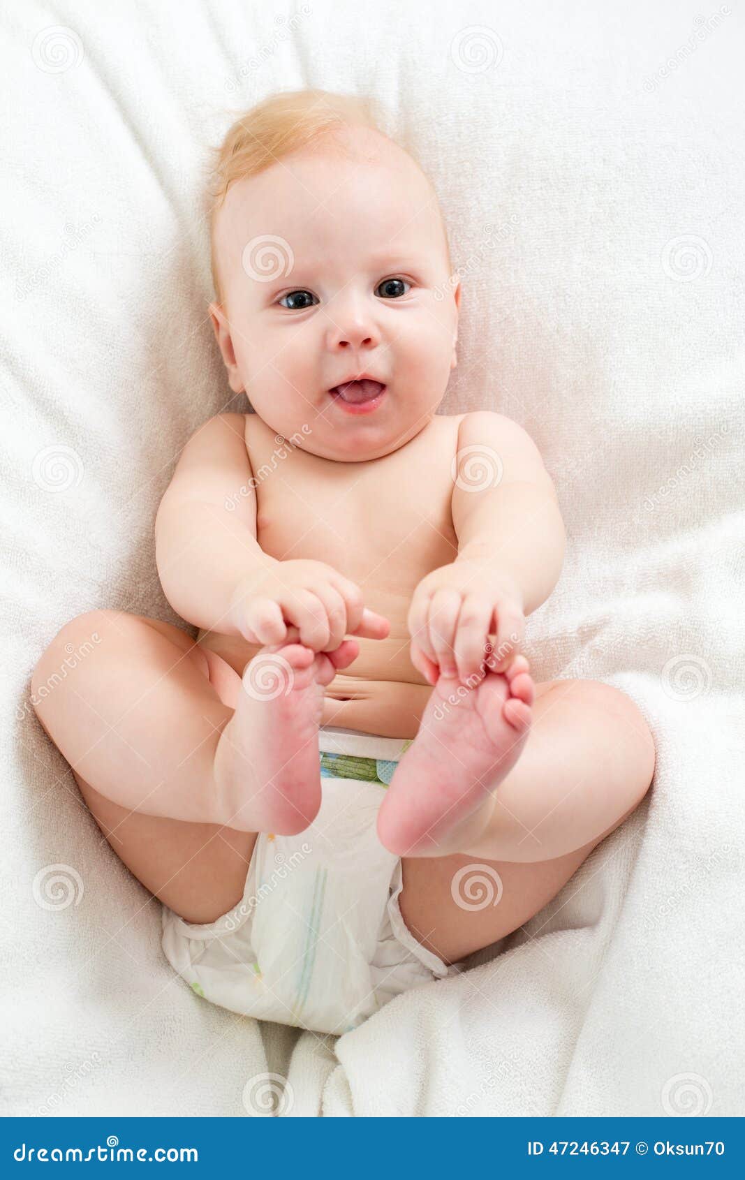 Baby Boy Lying on Bed and Holding Legs Stock Image Image of emotion