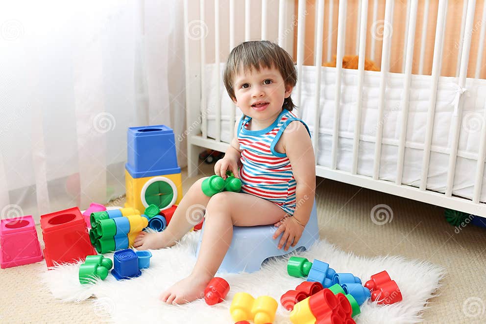 Baby boy sitting on potty stock image. Image of shot - 43431271