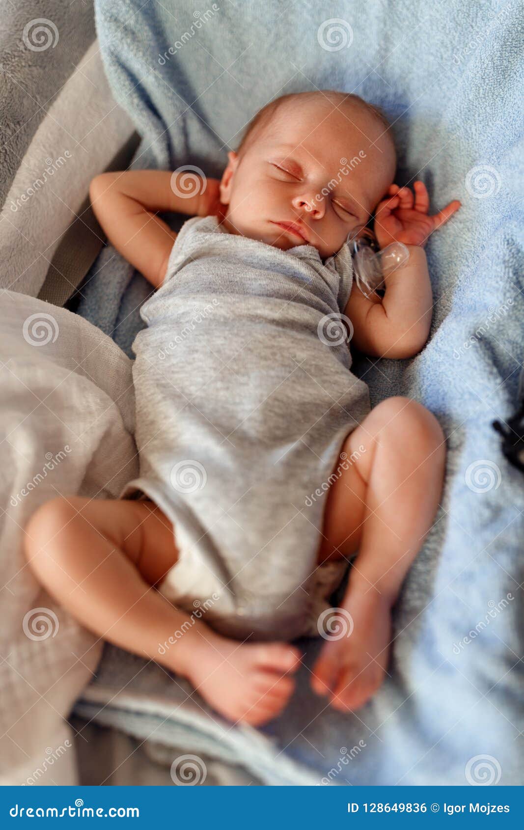 newborn sleeping in bouncer