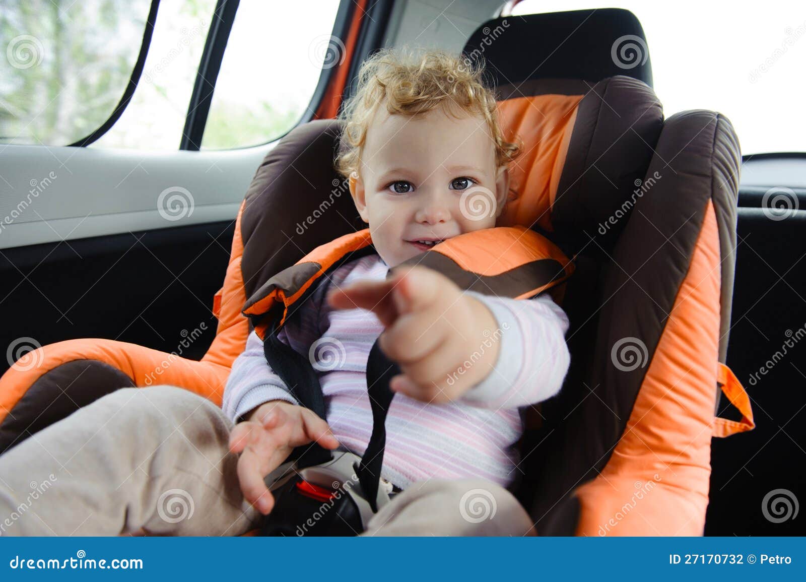 Baby in car seat. Cute baby enjoying a road trip in a baby car seat