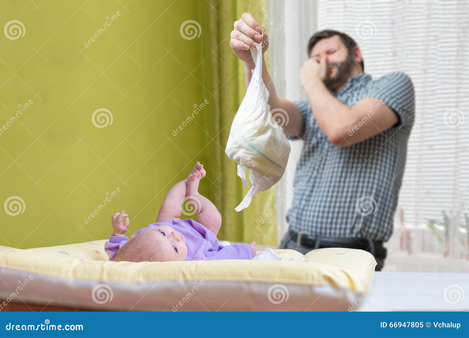 baby care concept. father od dad is changing stinky diaper