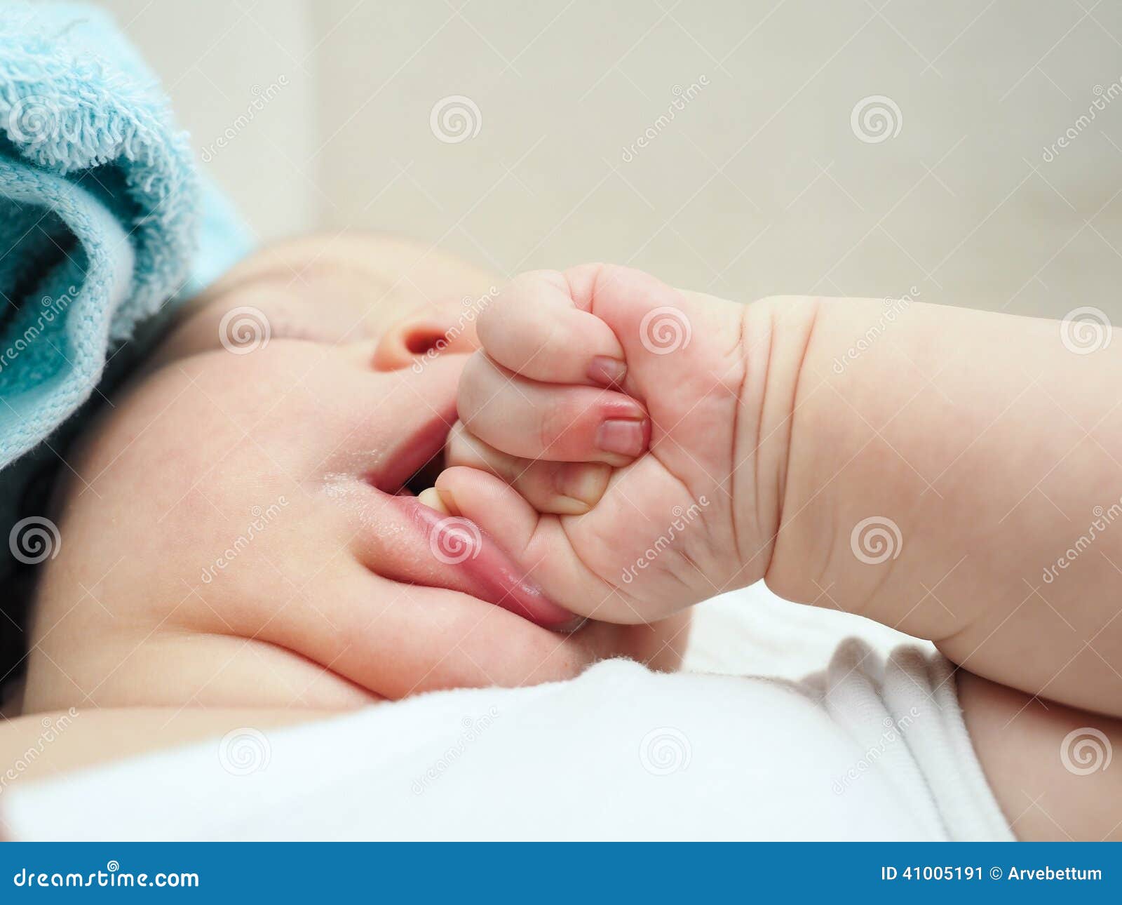 Baby chewing on hand stock image. Image of fist, close ...