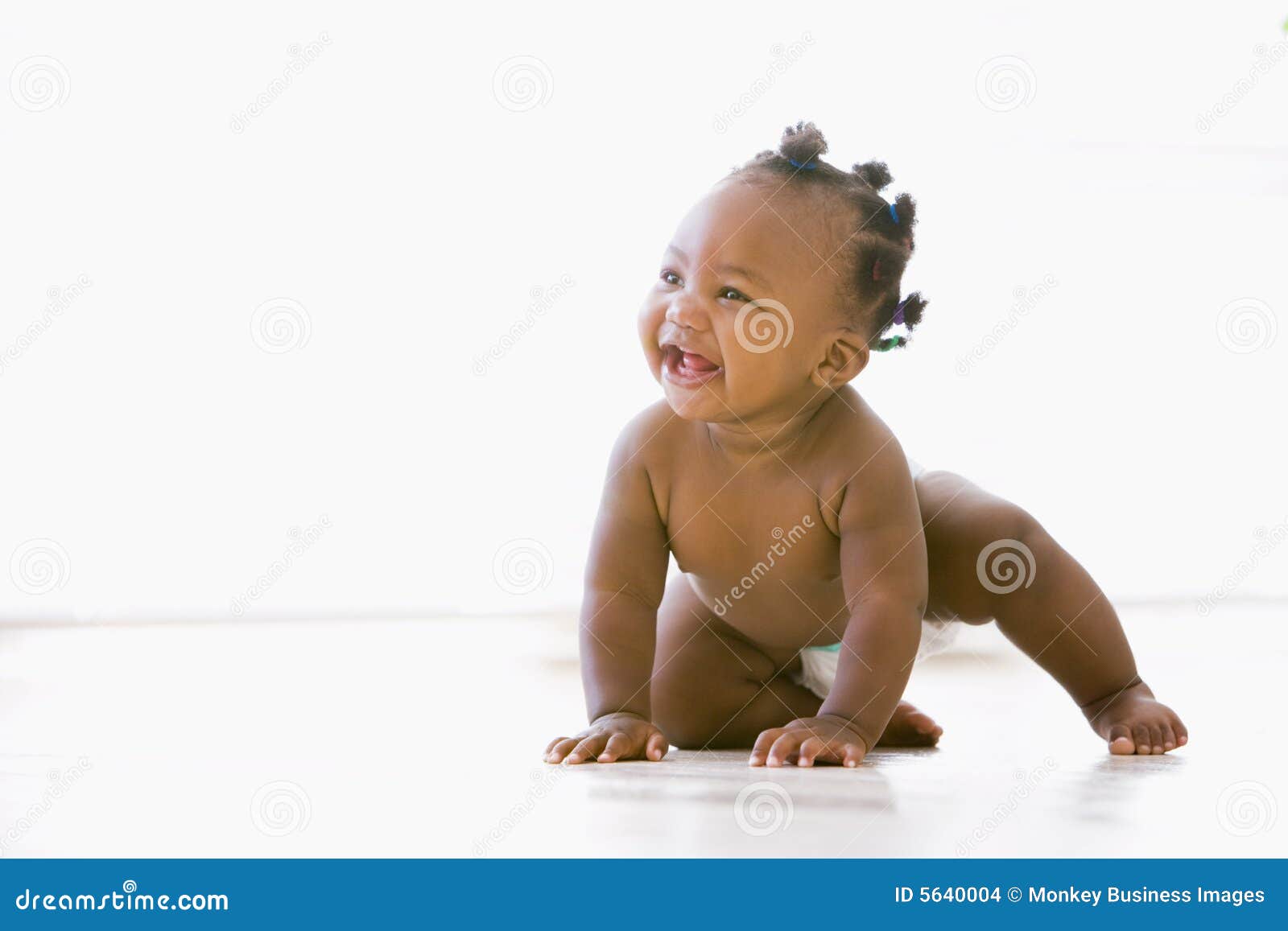 baby crawling indoors smiling