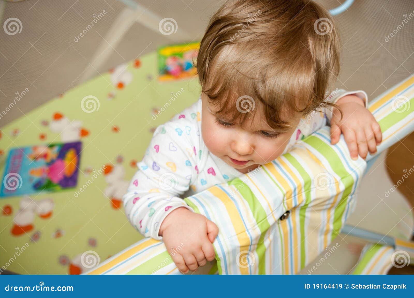 Baby in crib stock image. Image of gripping, play, holding 19164419