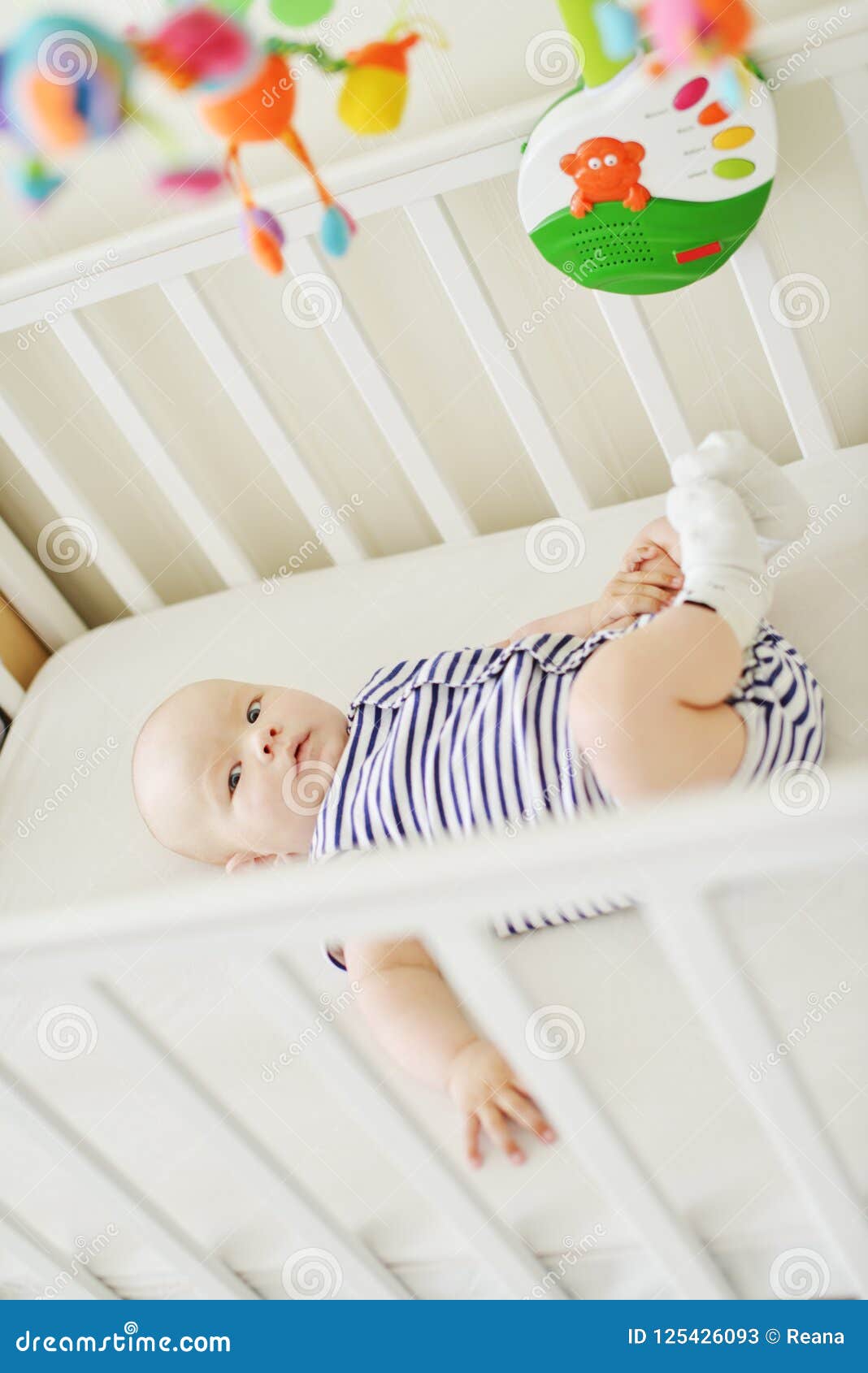 Baby in the crib stock image. Image of adorable, infant 125426093