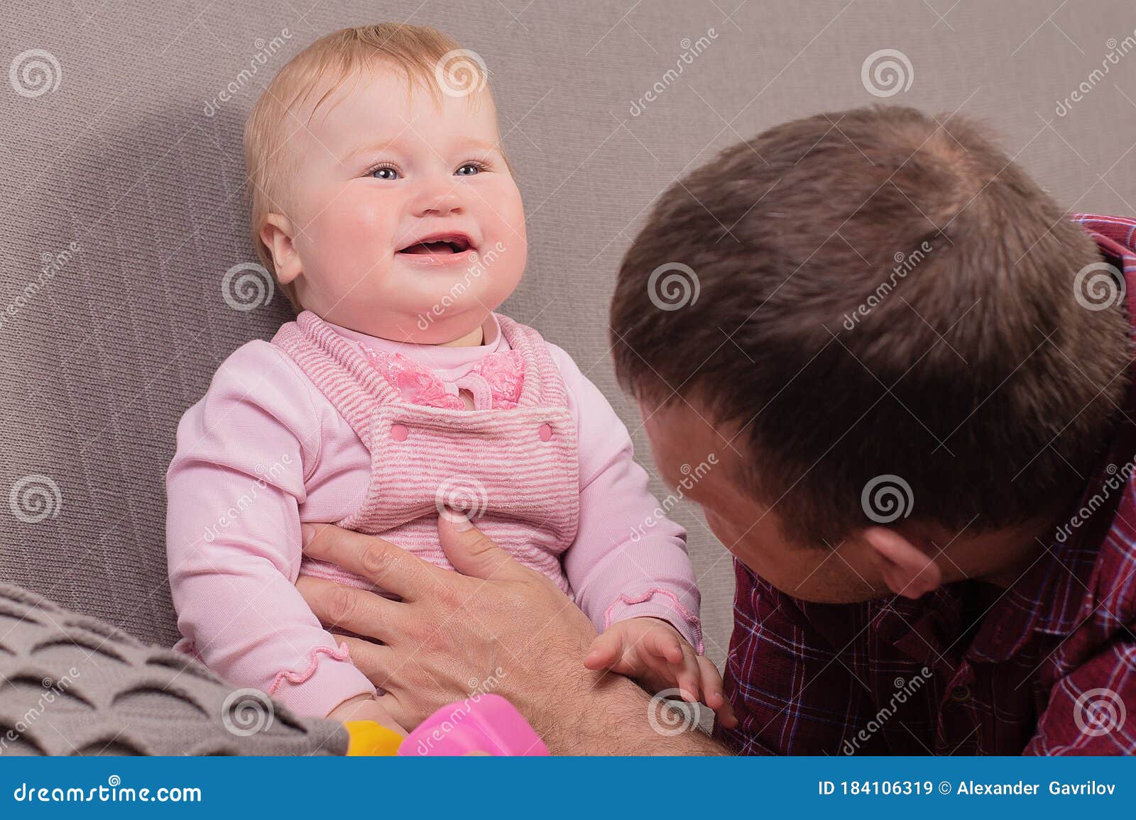 Baby And Daddy Dream Of A Pilot. Child Sits On Father`s Neck