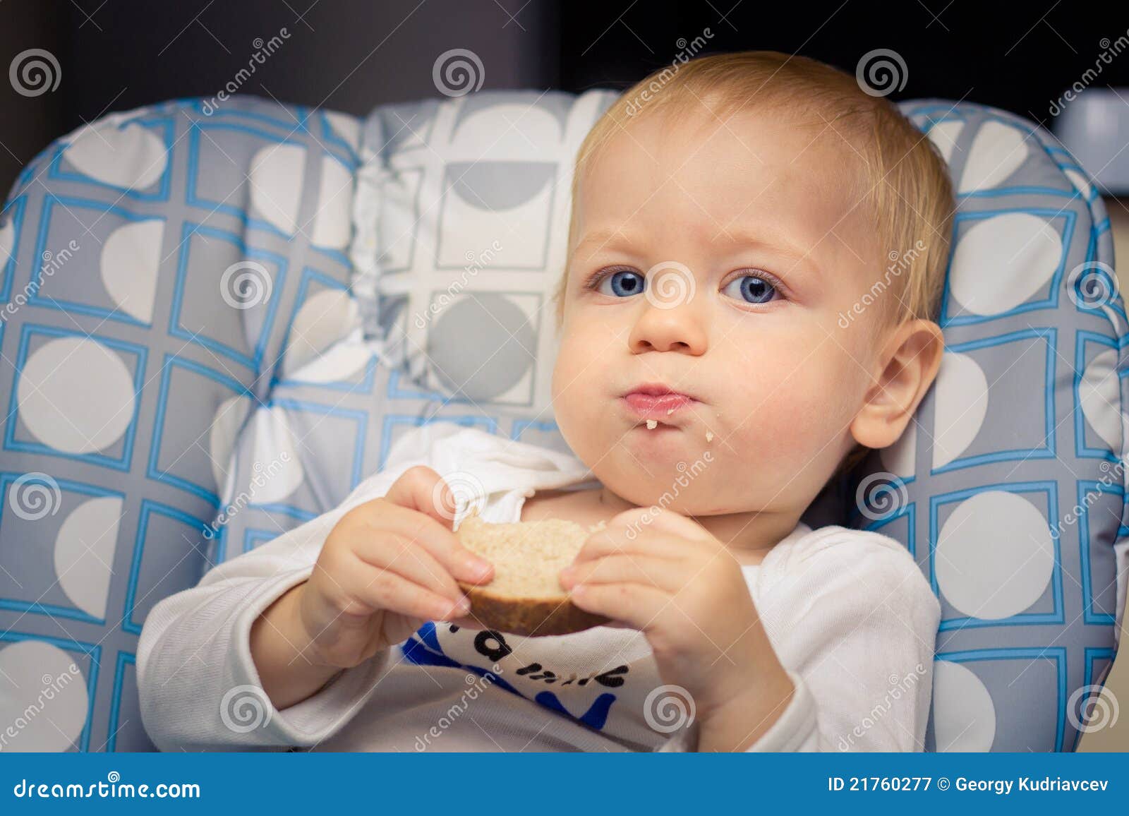 Baby eating bread stock image. Image of dinner, meal 21760277