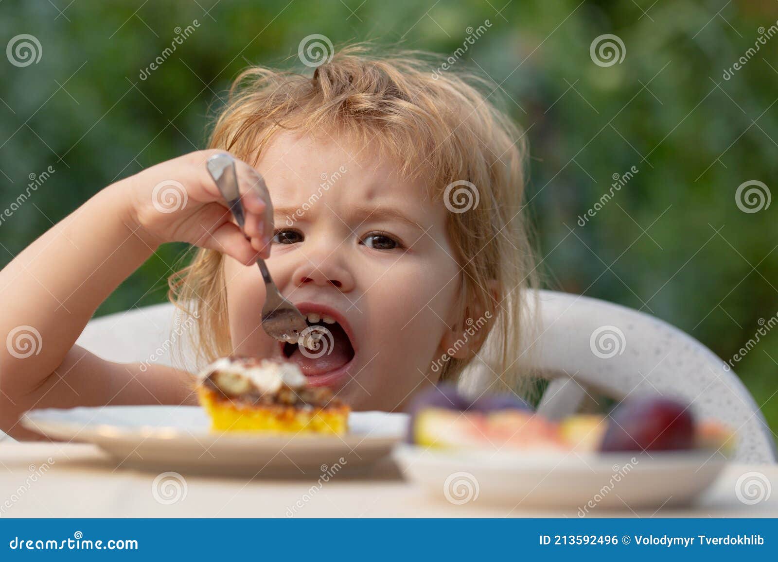 Baby Eating Cake. Child Eat Cupcake Outdoors. Stock Photo Image of