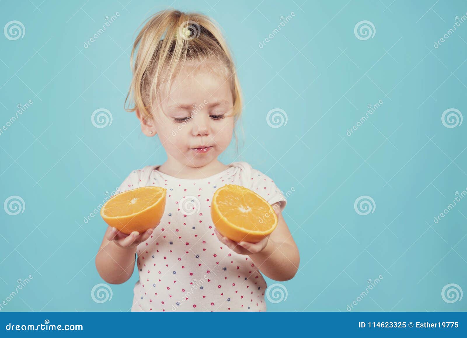 Baby eating an orange stock image. Image of blue, drink - 114623325