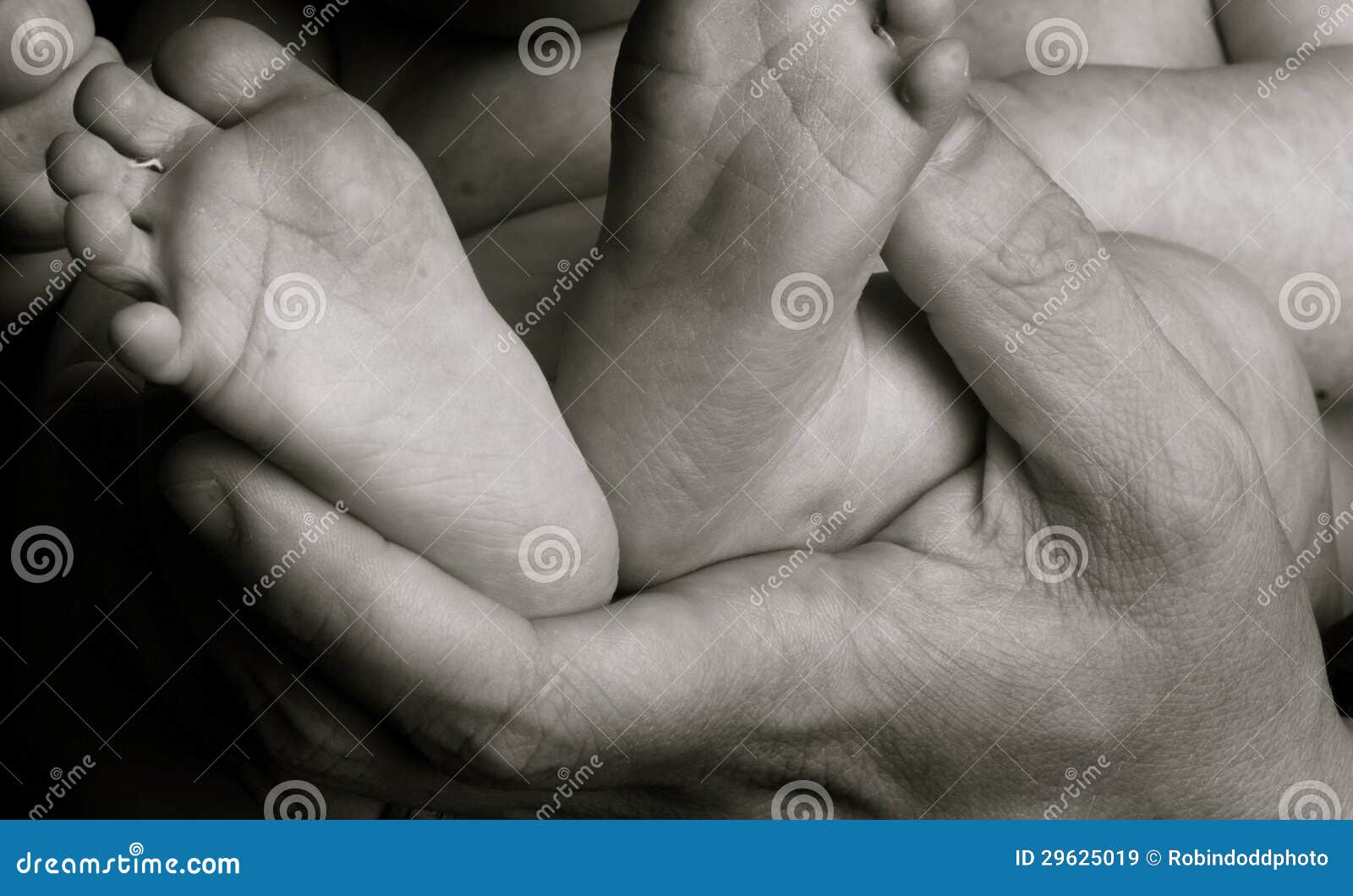 baby feet and daddy's hands
