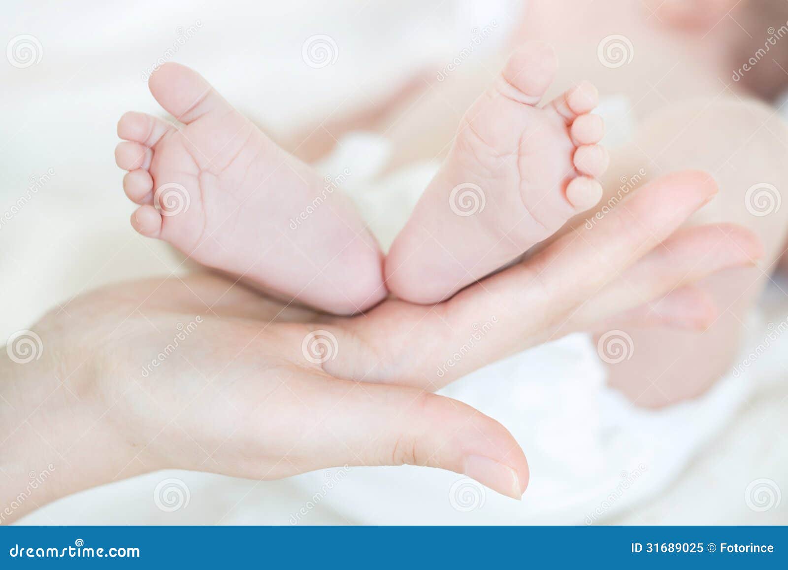 Royalty-Free photo: Person holding baby's foot