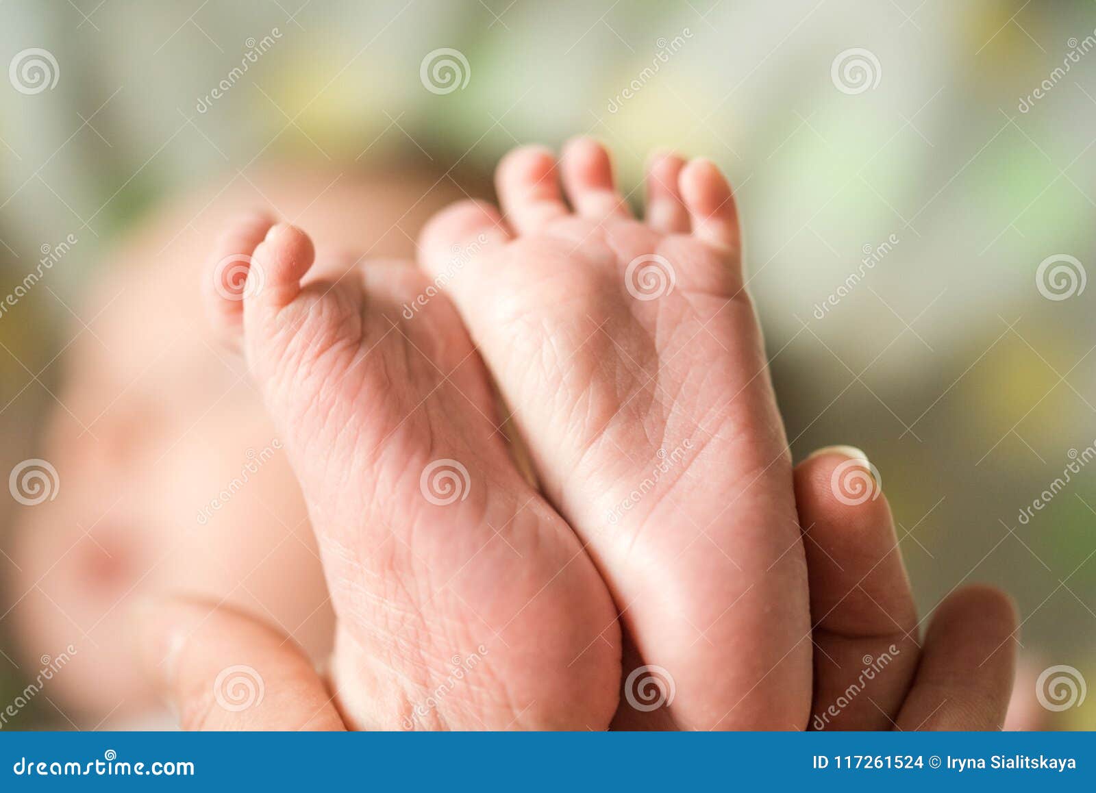 Baby feet in mother hands mom and her child happy family concept beautiful